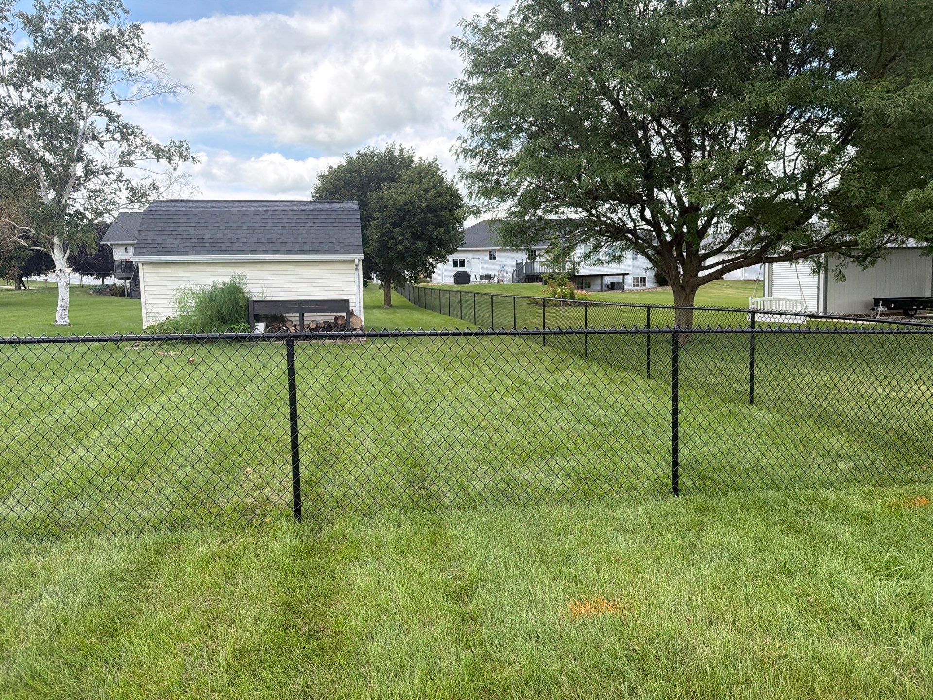 Black Vinyl-Coated Chain Link Fence Installation in Fairbank by Perfect Picket Fence and Stain