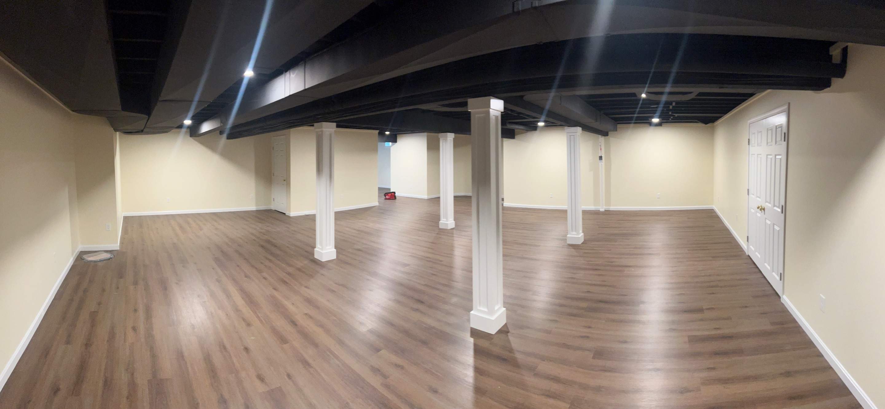 Basement Remodel w/ LVP Flooring & Exposed Ceiling by Chagnon Building & Remodeling LLC