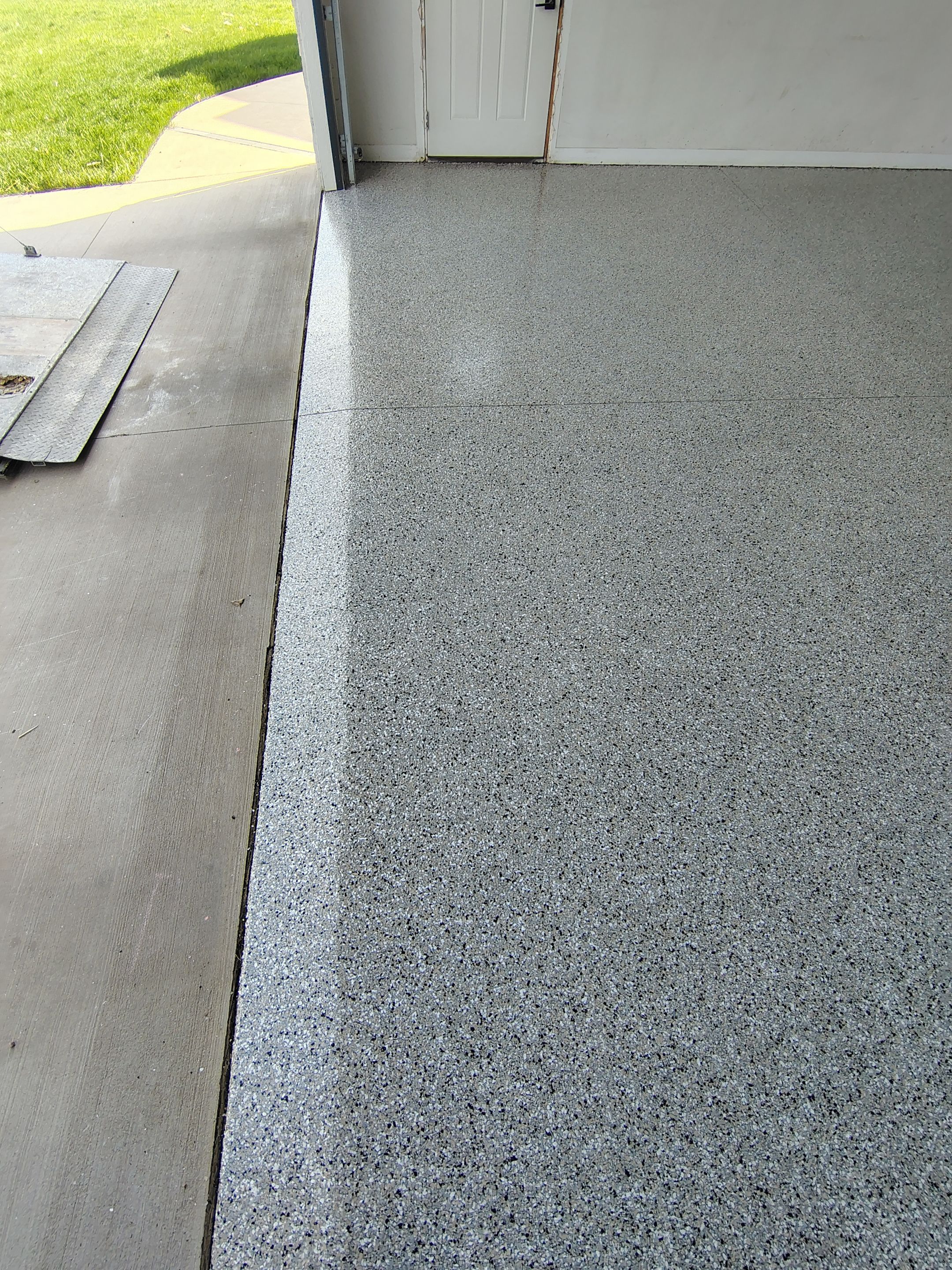 Speckled Polyaspartic Garage Floor Coating Installation in Dell Rapids by Select Painting, Coatings & Garage Cabinets