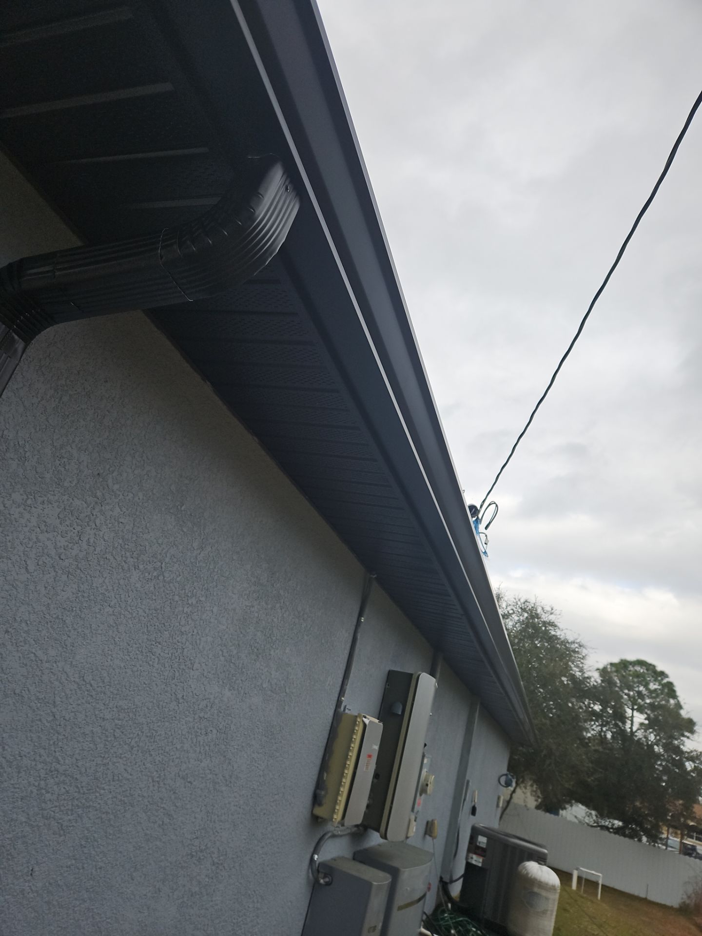 Black Seamless Gutters & Soffit/Fascia in Lehigh Acres FL by Gutter Professors