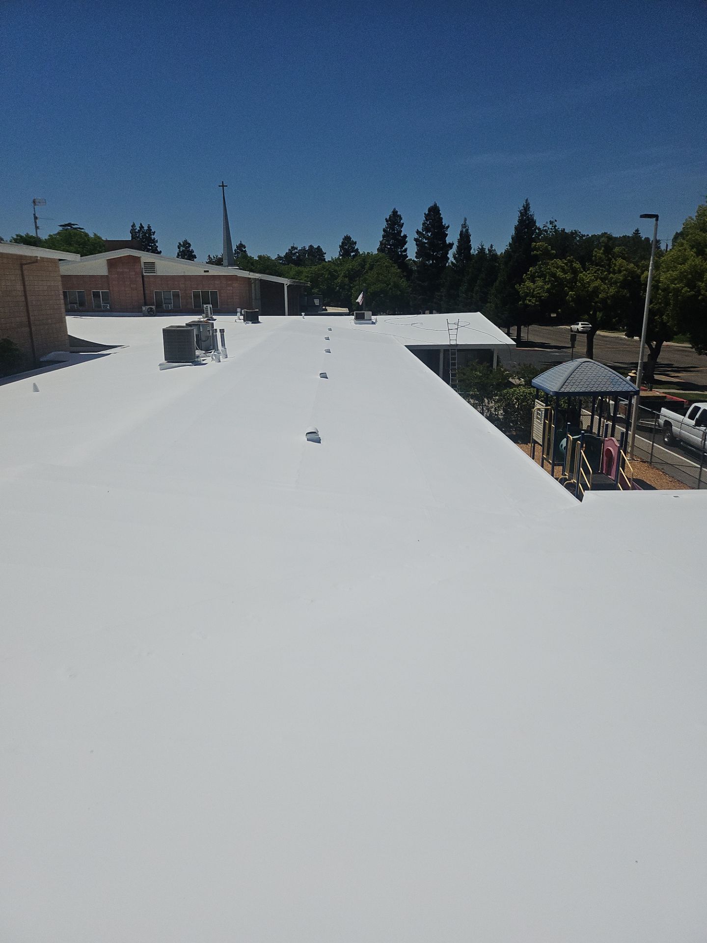 Single-ply restoration system using Benchmark/PUMA XL coatings over TPO single-ply roofing by Straight Edge Roofing Inc