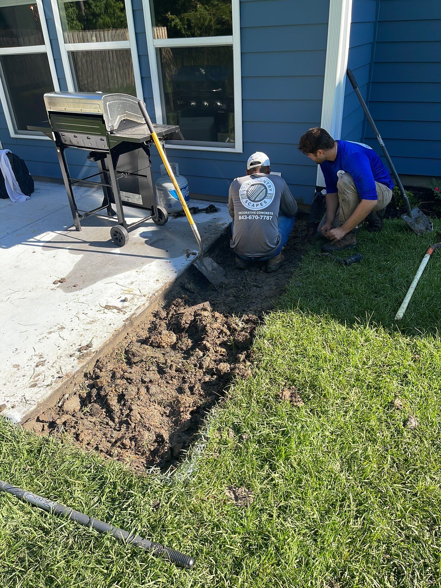 Concrete Patio Extension and Utility Line Preparation in Okatie by Lowcountry Scapes, LLC