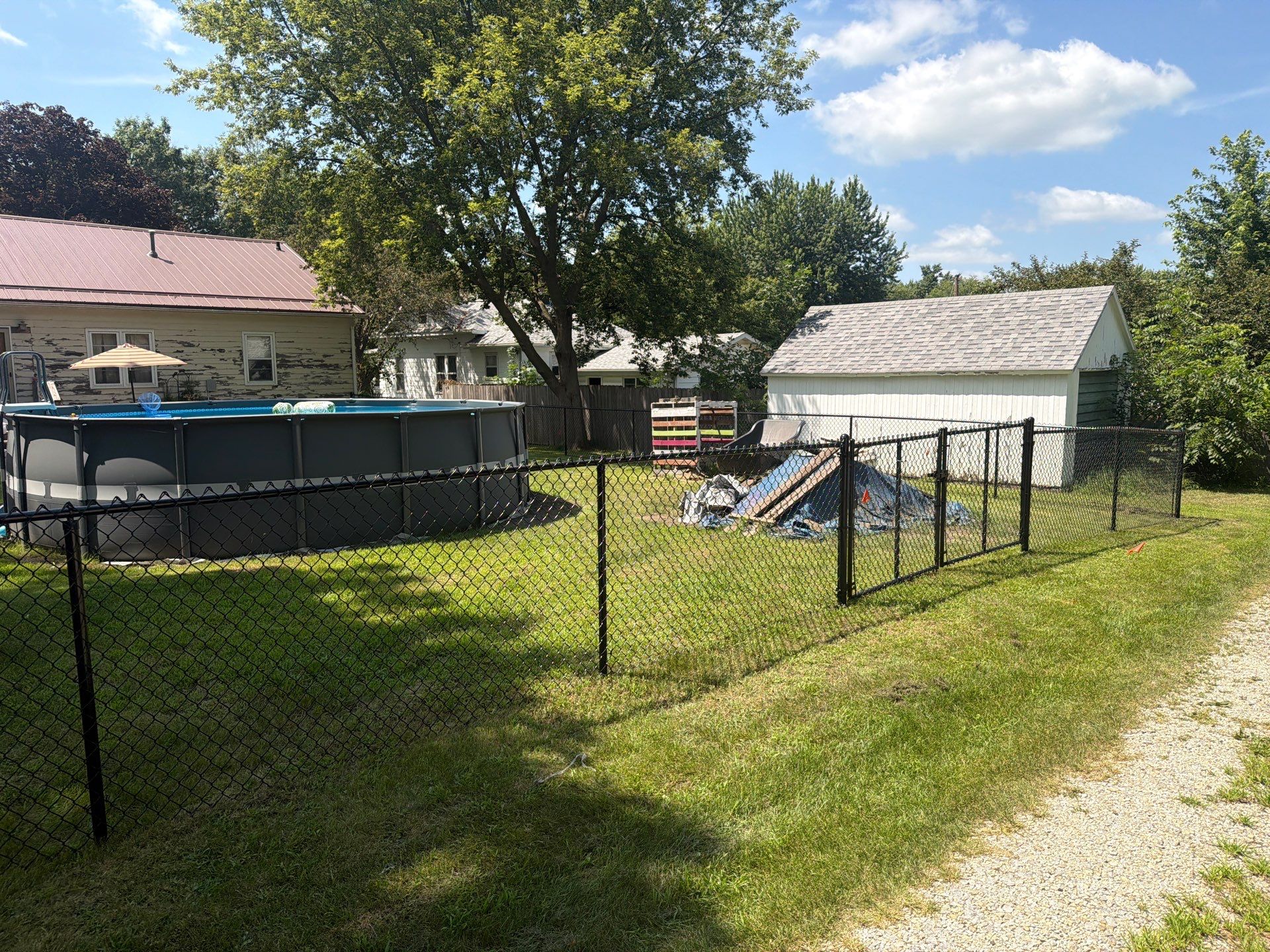 Black Chain Link Backyard Fence Installation in Tripoli, IA by Perfect Picket Fence and Stain