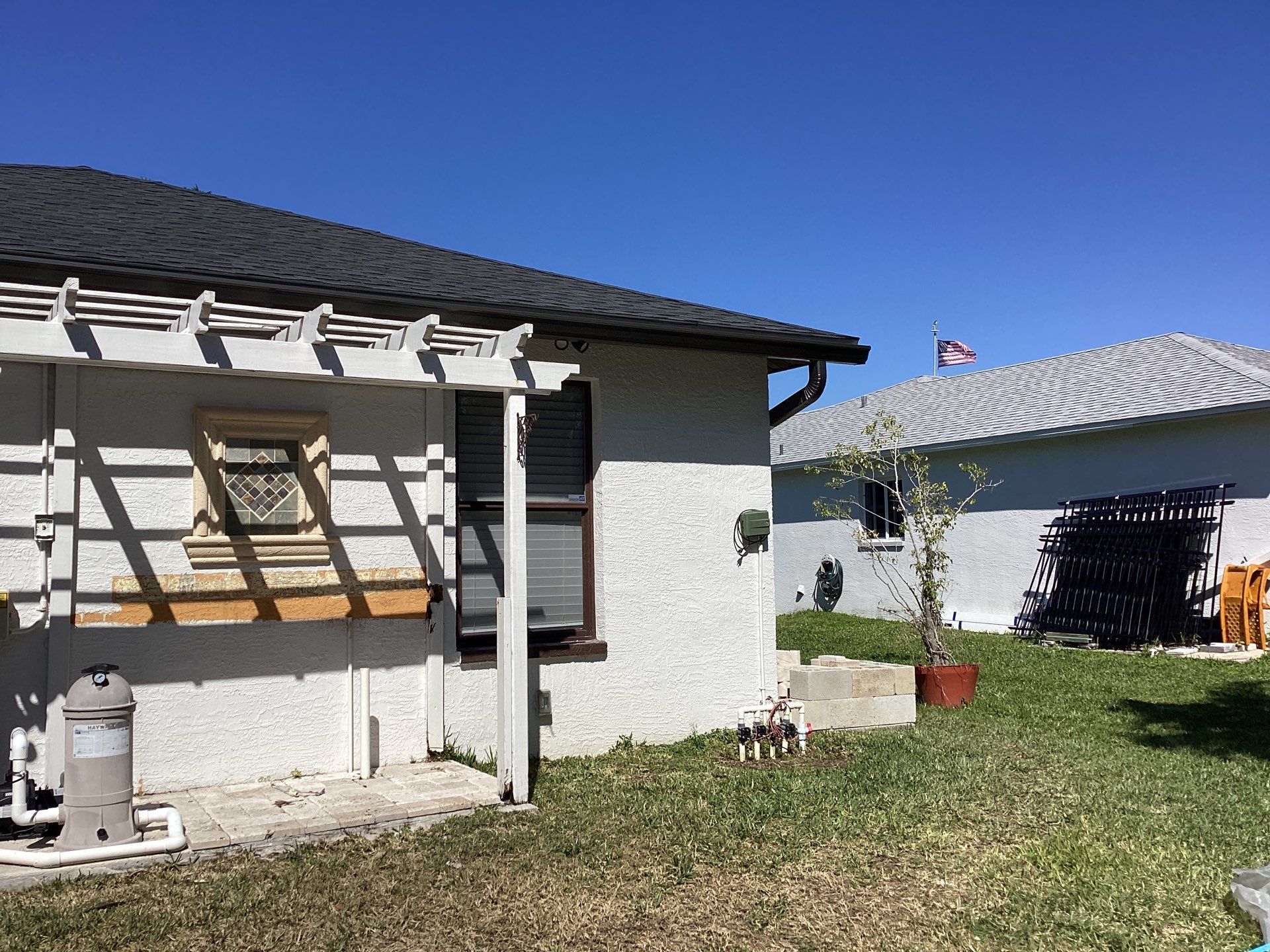 Brown Gutter + White and Brown Downspouts in Cape Coral FL by Gutter Professors