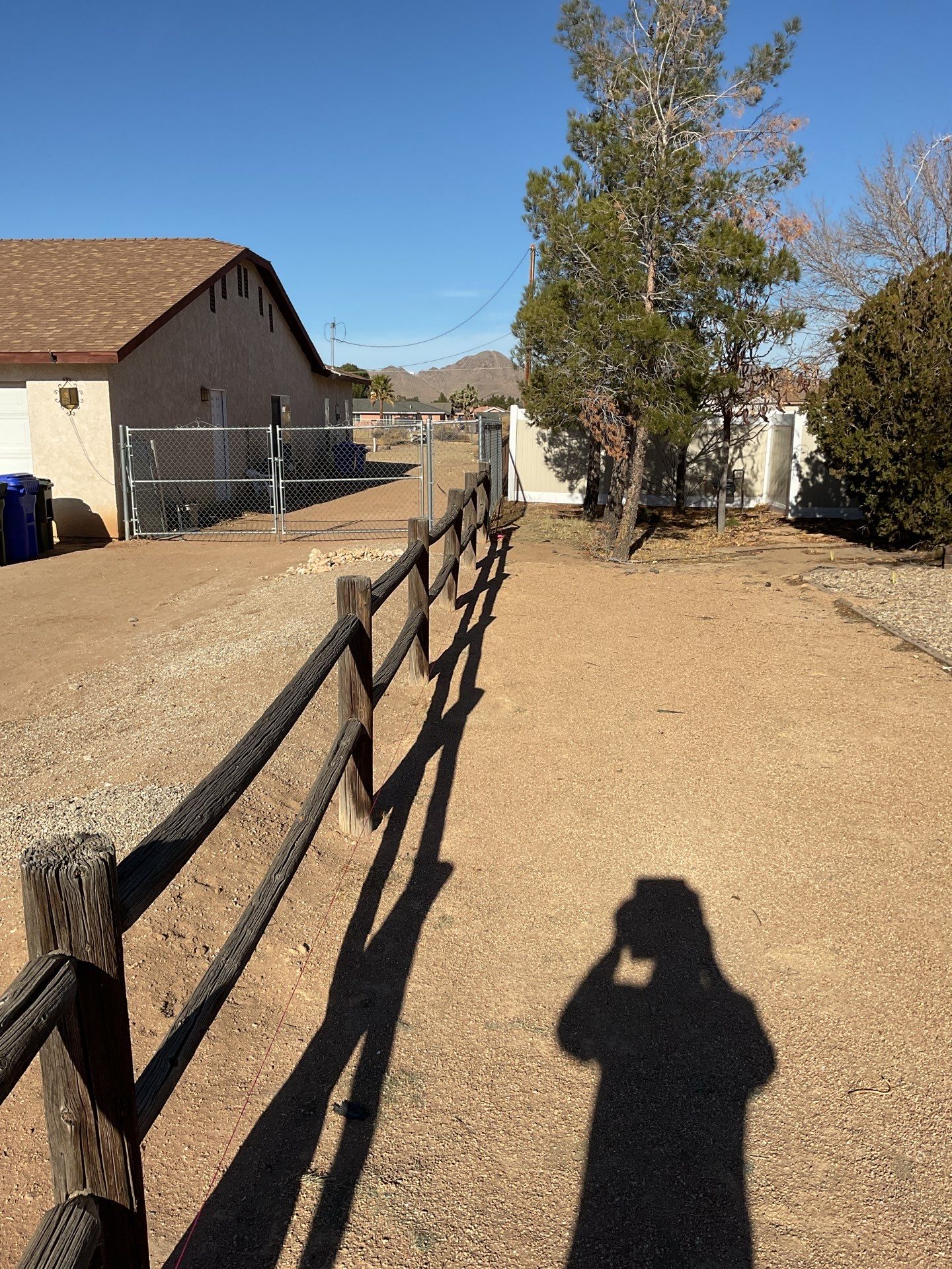 Sleek chain link fence installation with a solar motorized gate by Fence Guys Inc.