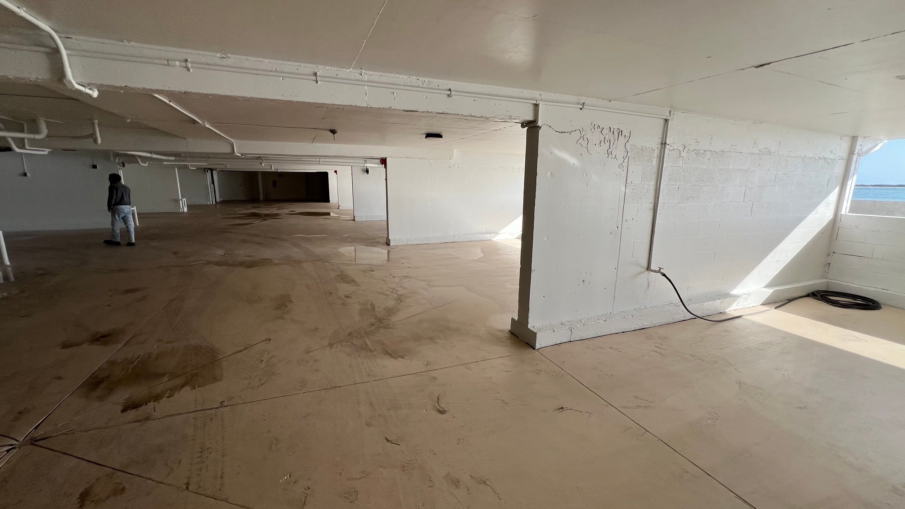 Isles of Capri Condo Parking Garage Drainage System Cleaning by APS Power & Water
