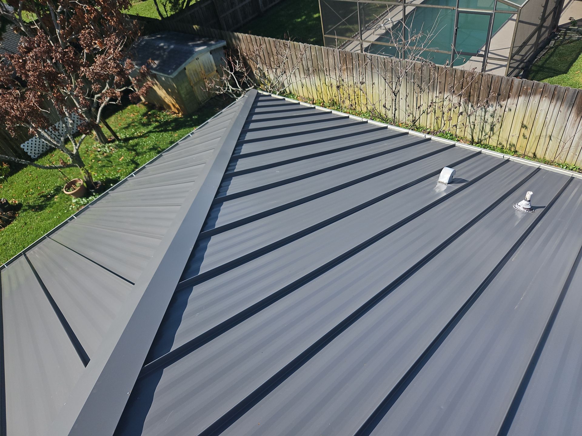 Complete Metal Roof Replacement and Seamless Gutter Installation in Melbourne by Wiedmann Construction & Roofing