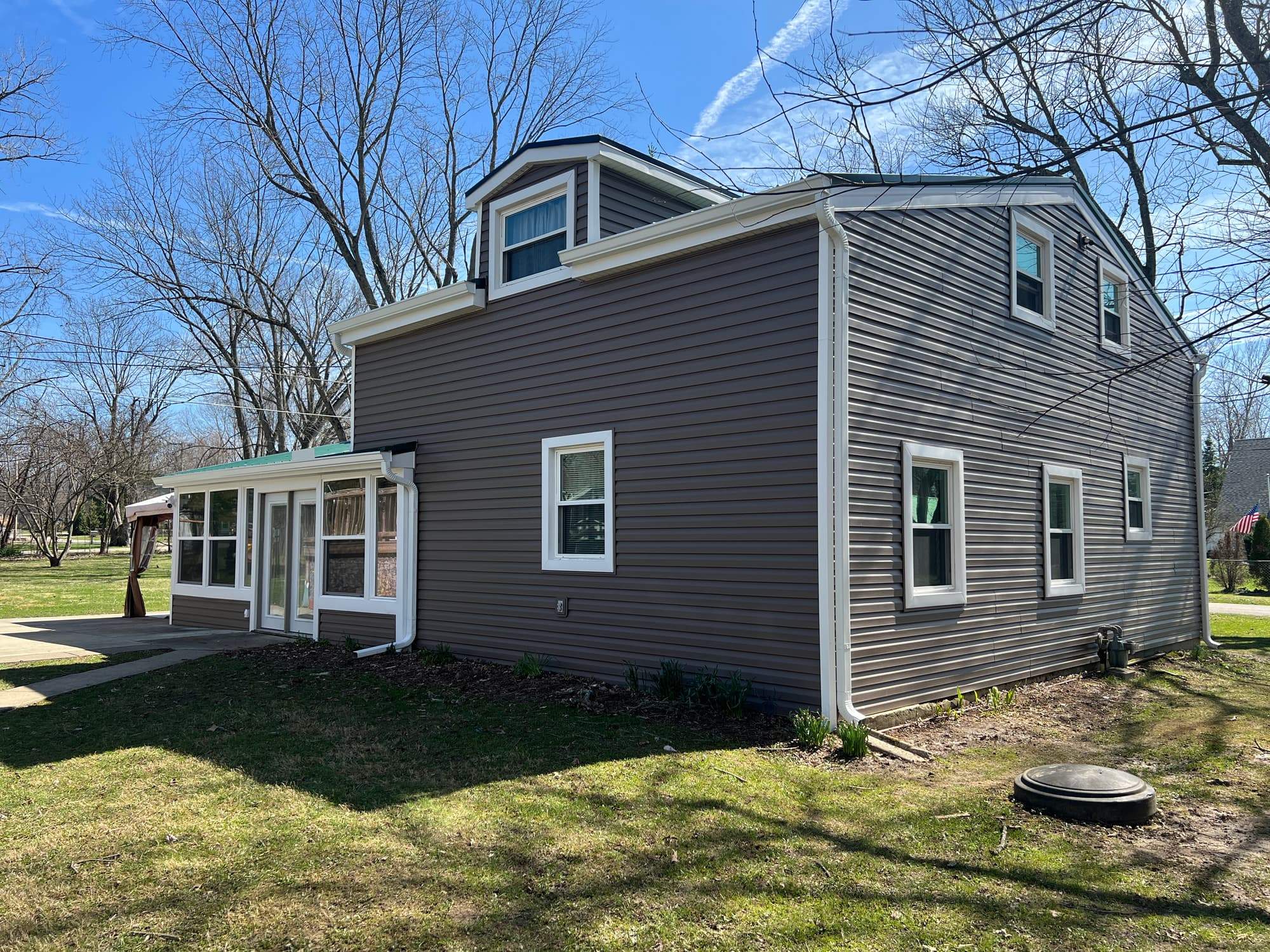Green Metal Roof Installation and Exterior Renovation in Thornville by Canopy Contracting