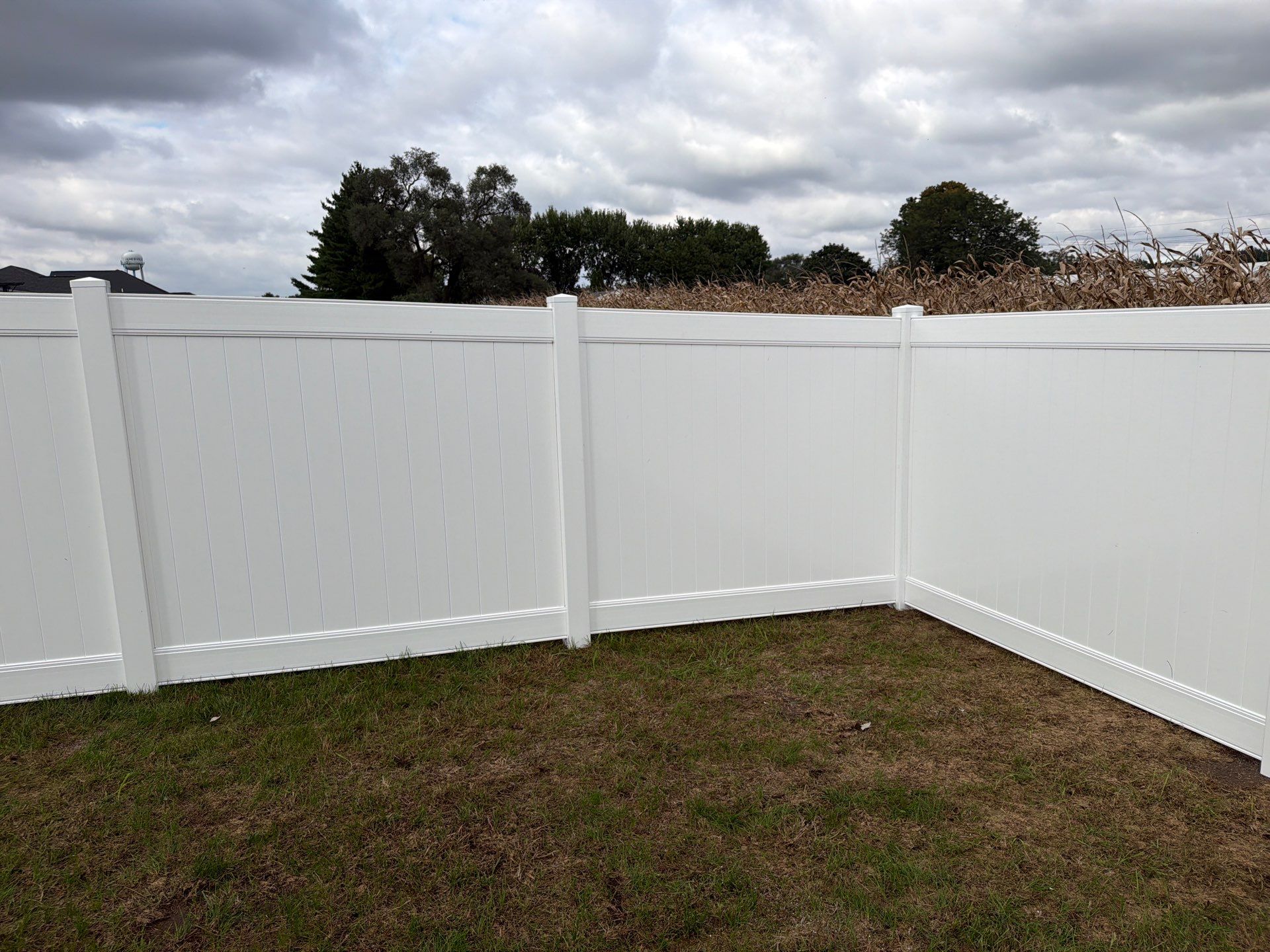 Residential White Vinyl Privacy Fence Installation in Janesville by Perfect Picket Fence and Stain