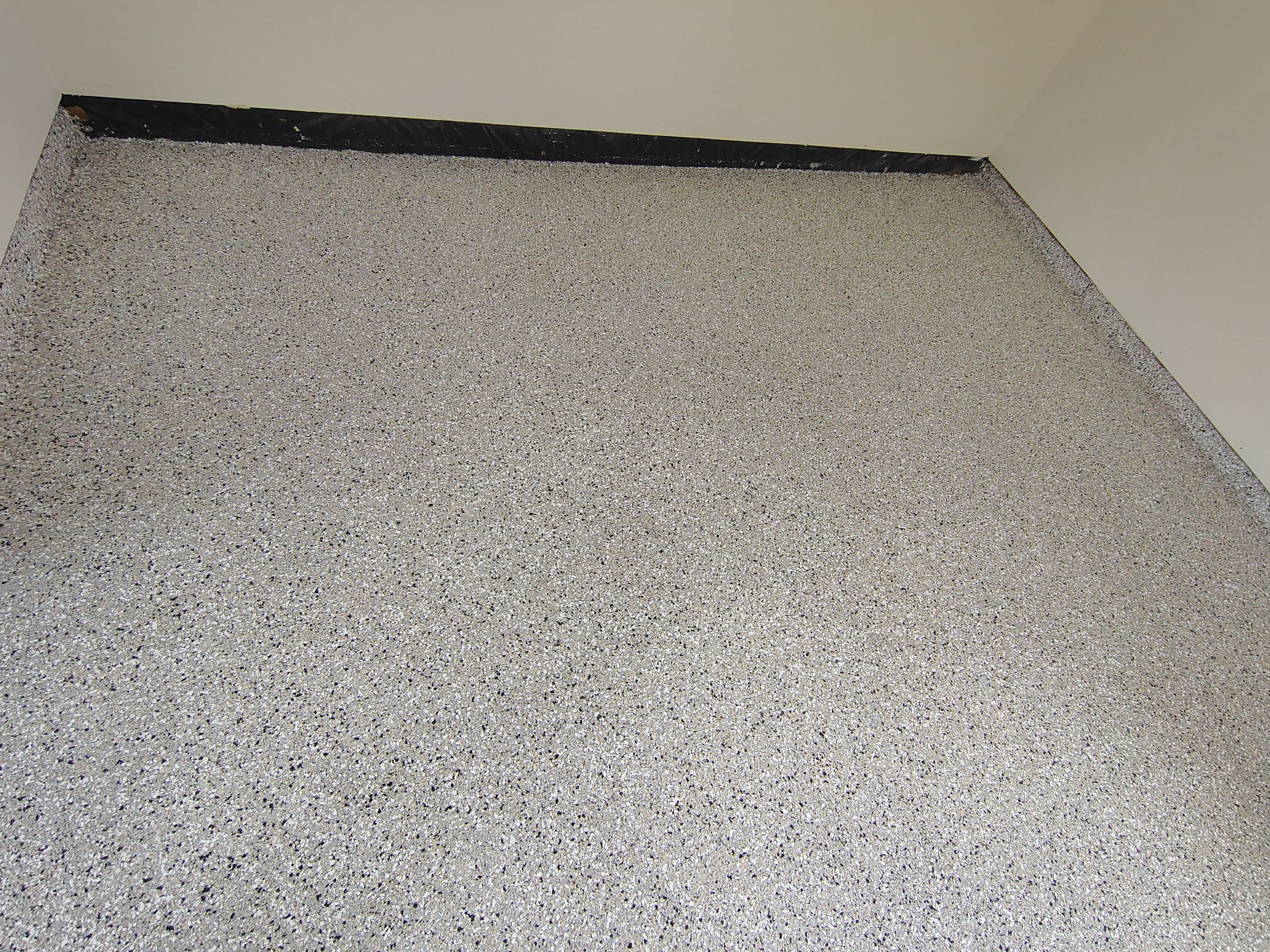 Full-Flake Epoxy Garage Floor Coating Installation in Sioux Falls by Select Painting, Coatings & Garage Cabinets