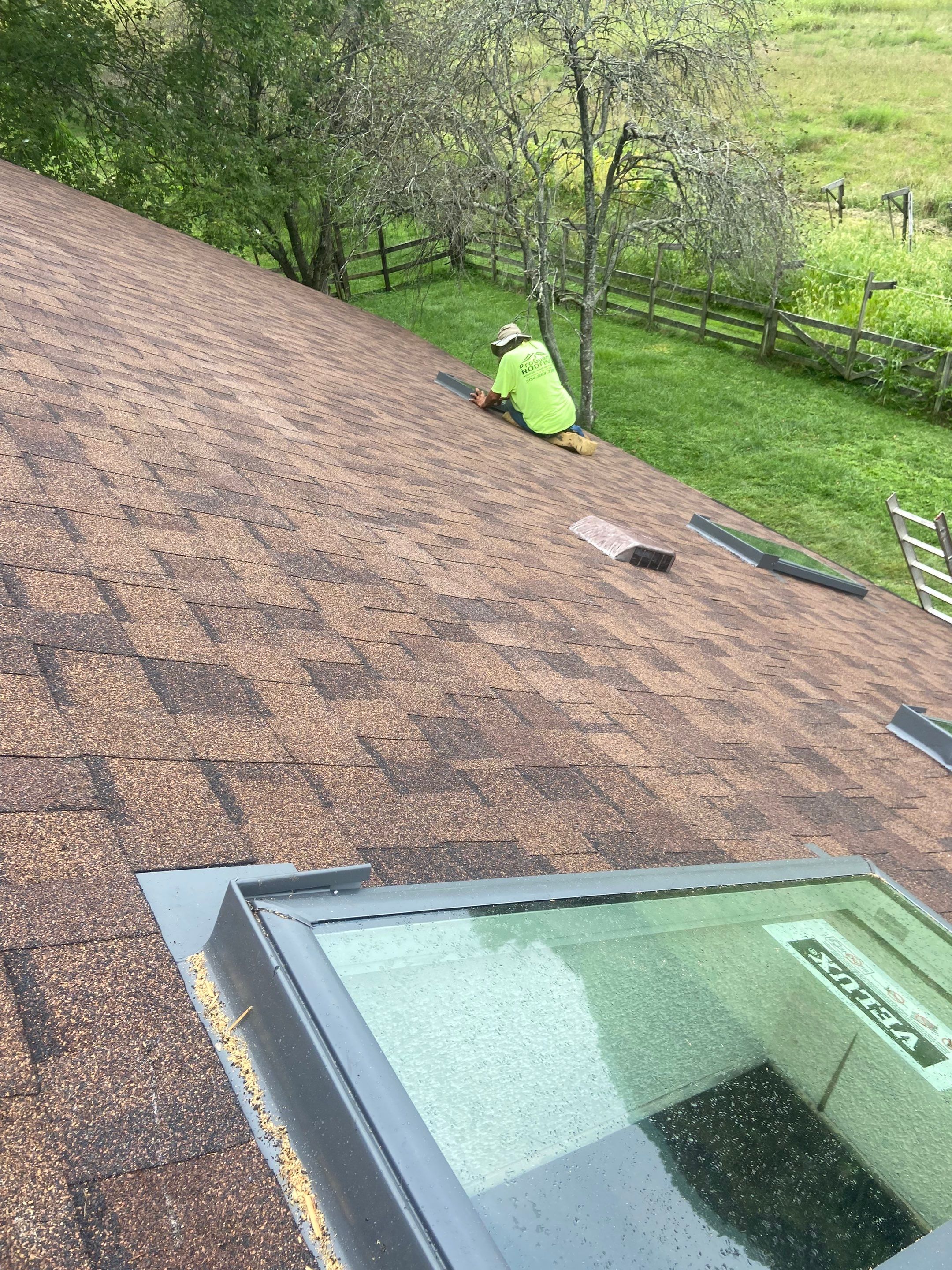Shingle Roofing with Velux Skylight replacement and stone chimney flashing  by Secure Construction Company Inc