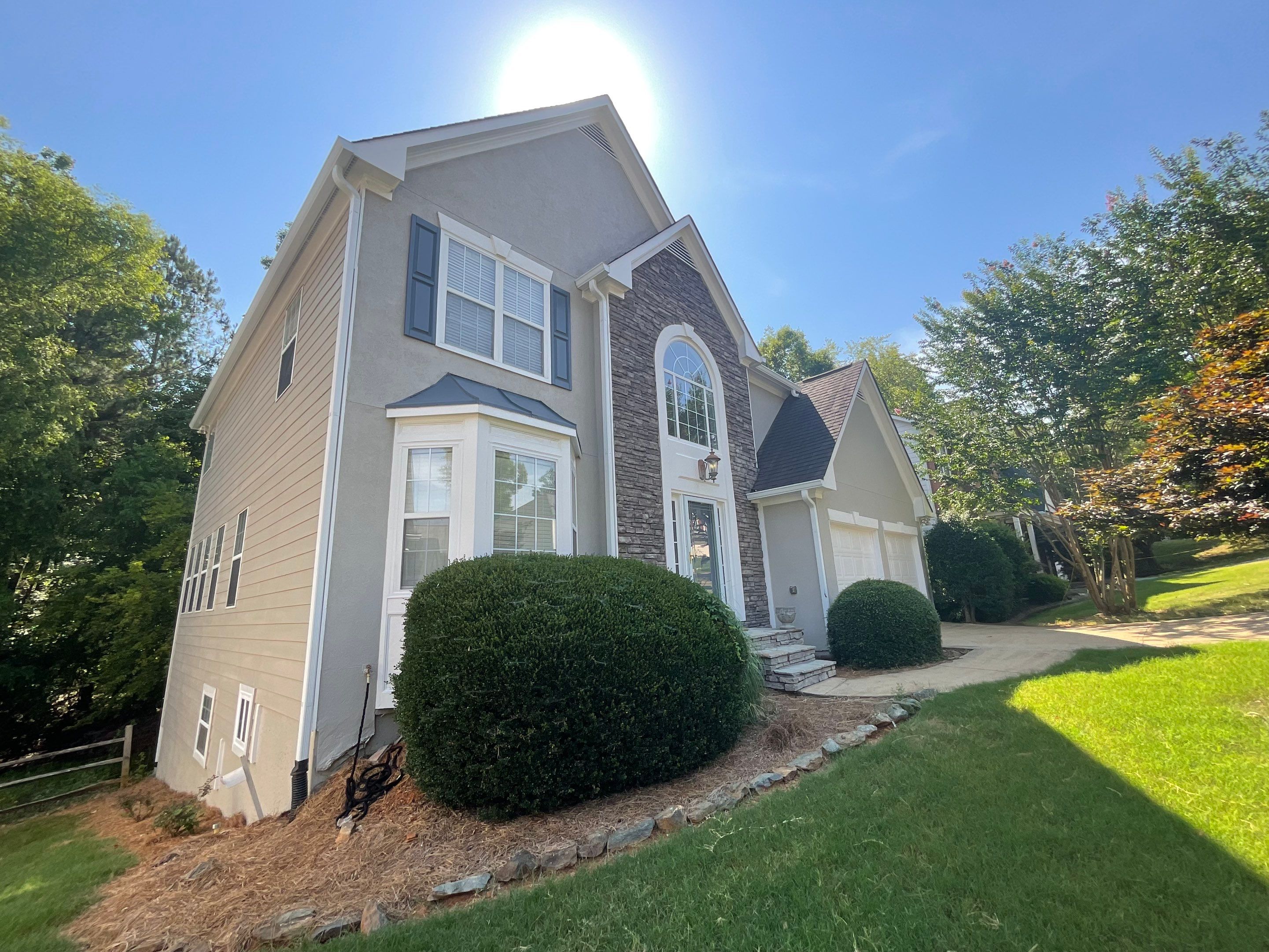 Stucco and Siding Exterior Painting with New Gutters in Kennesaw by Swift Home Renovations