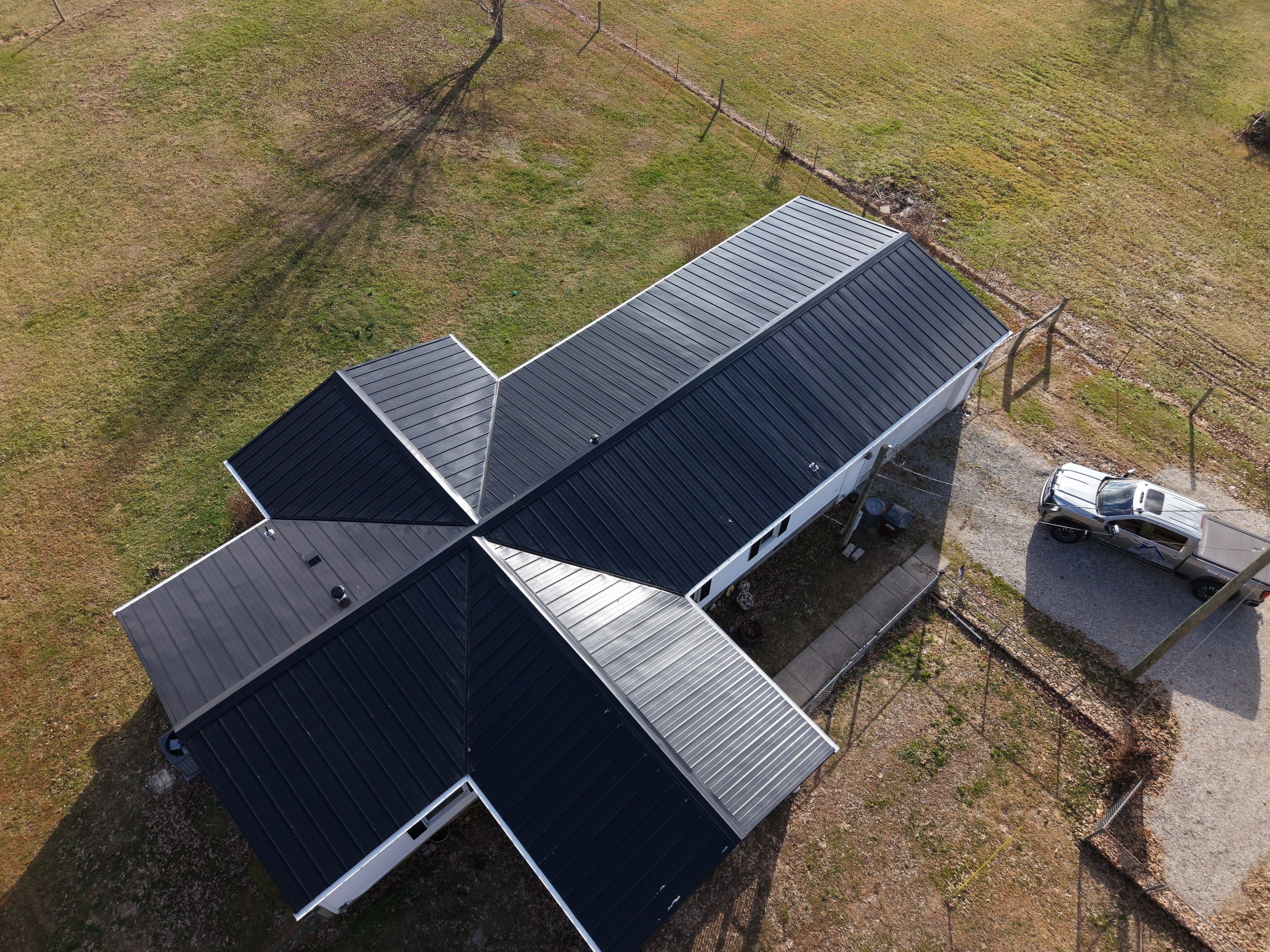 Standing Seam Roof & Black Gutters by Stout Exteriors