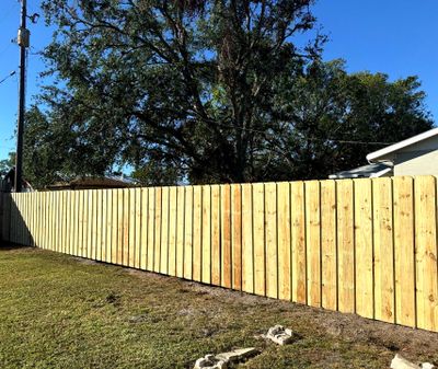 Wood Fence Installation using 6Ft Pressure Treated Wood Board On Board Privacy Fence