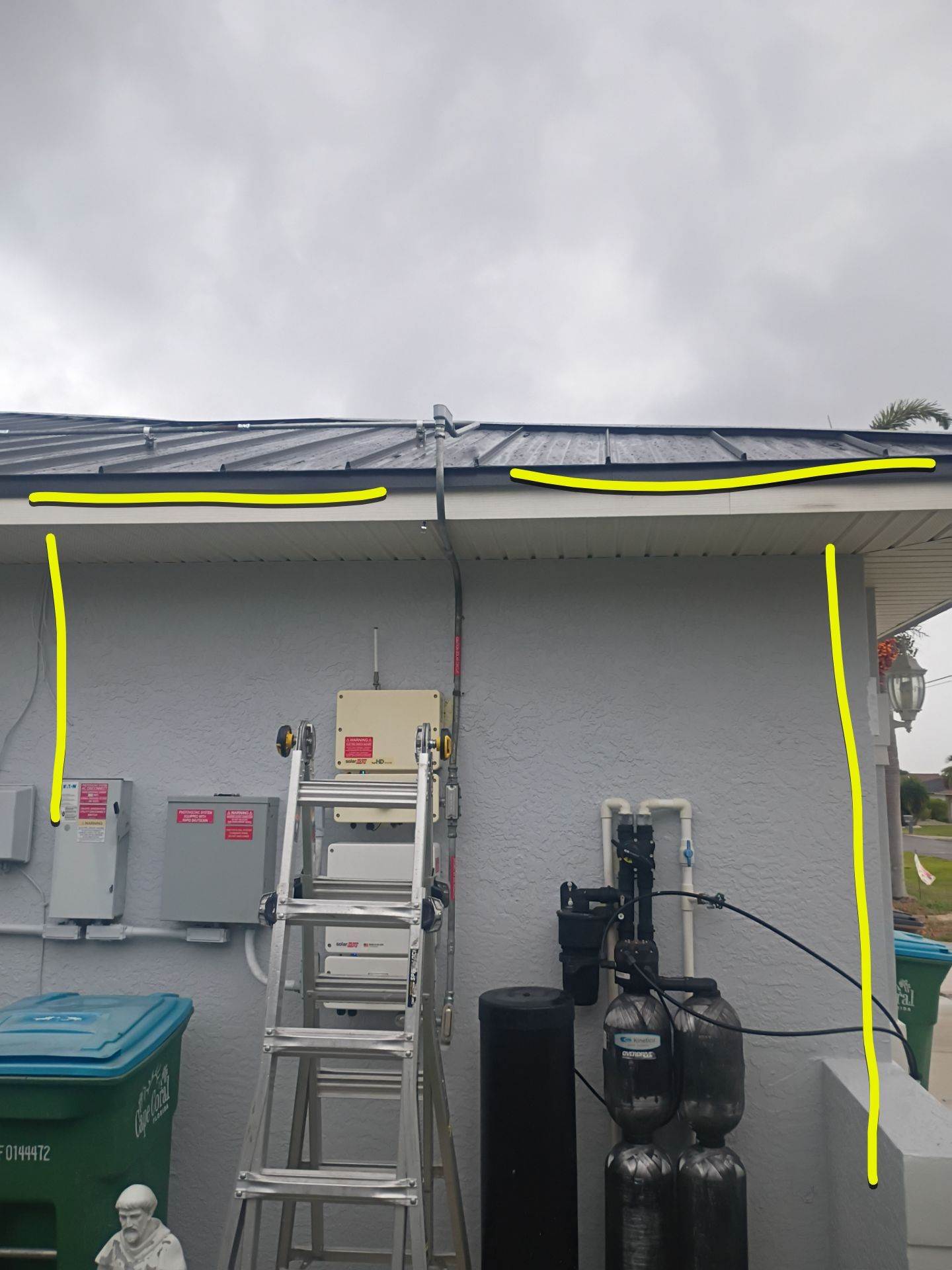 Black Seamless Gutters and White Downspouts in Cape Coral FL by Gutter Professors