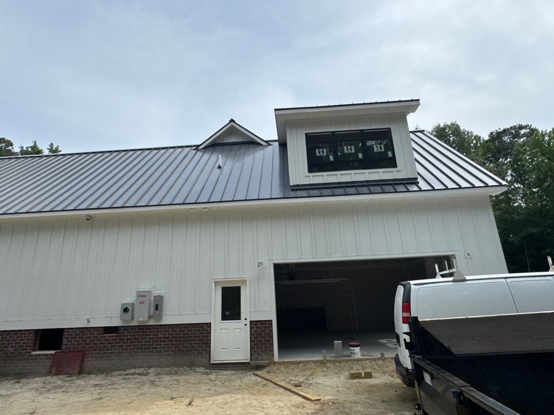 Custom New Construction Home Featuring Standing Seam Metal Roofing in Port Haywood by Cade Construction