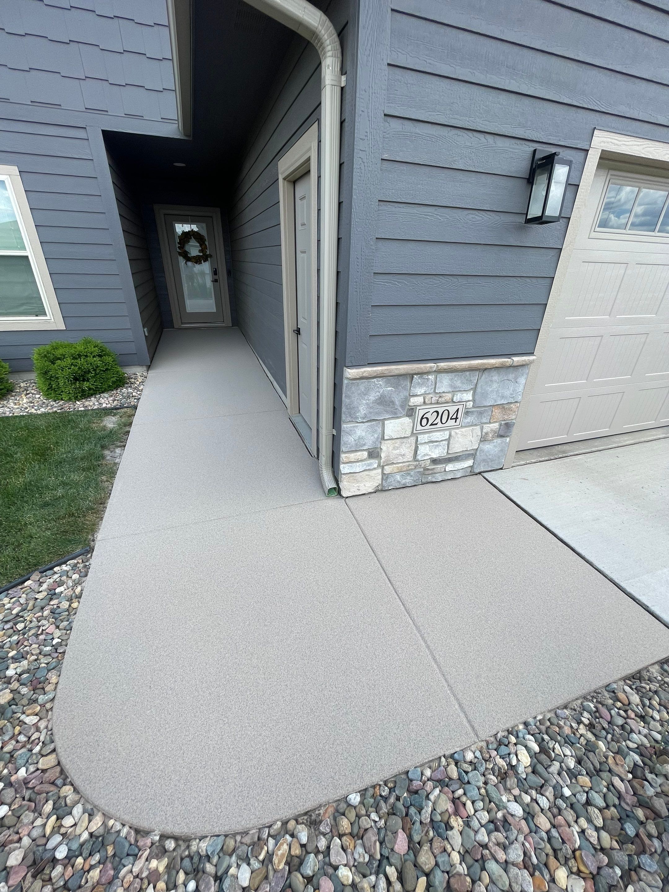 Textured Concrete Patio Coating and Custom Privacy Pergola in Sioux Falls by Select Painting, Coatings & Garage Cabinets