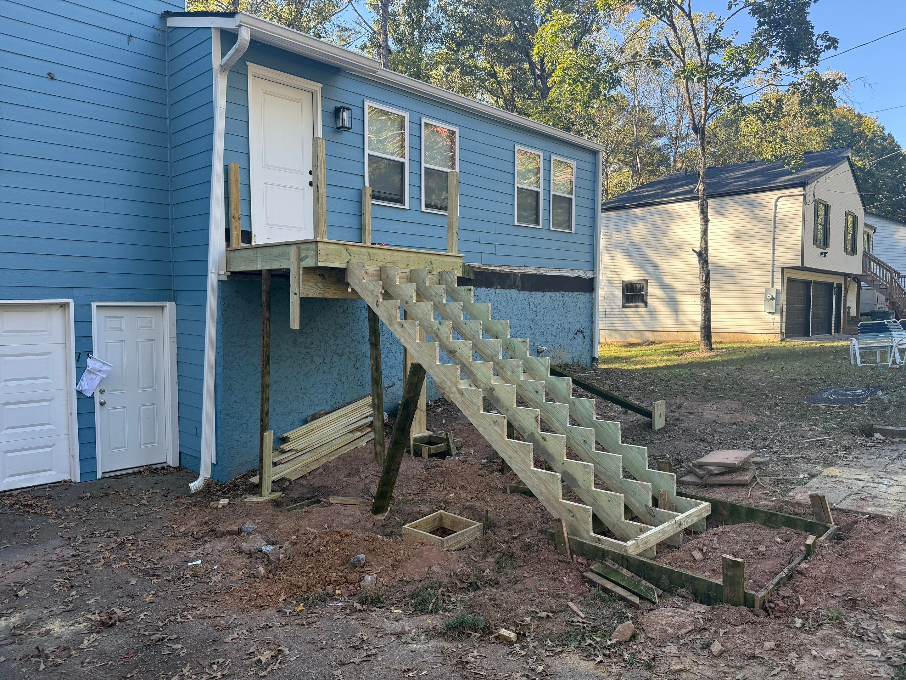 Custom Pressure-Treated Wood Staircase and Landing Installation by Swift Home Renovations