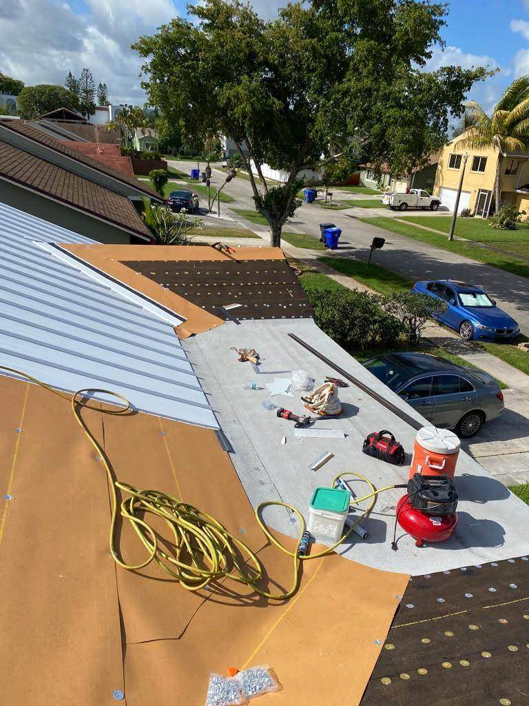 Standing Seam Metal & Flat Re-Roof using 1.5" Nail Strip 24ga Solar White Kynar Coated Standing Seam Metal Panels by Morton Roofing, Inc.