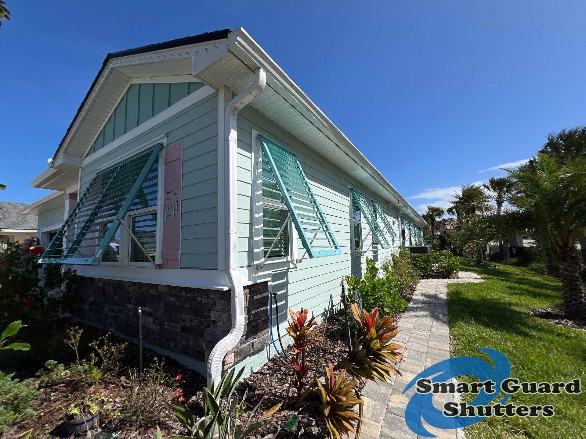 Impact Bahama Shutters in Pastel Turquoise by Smart Guard Shutters