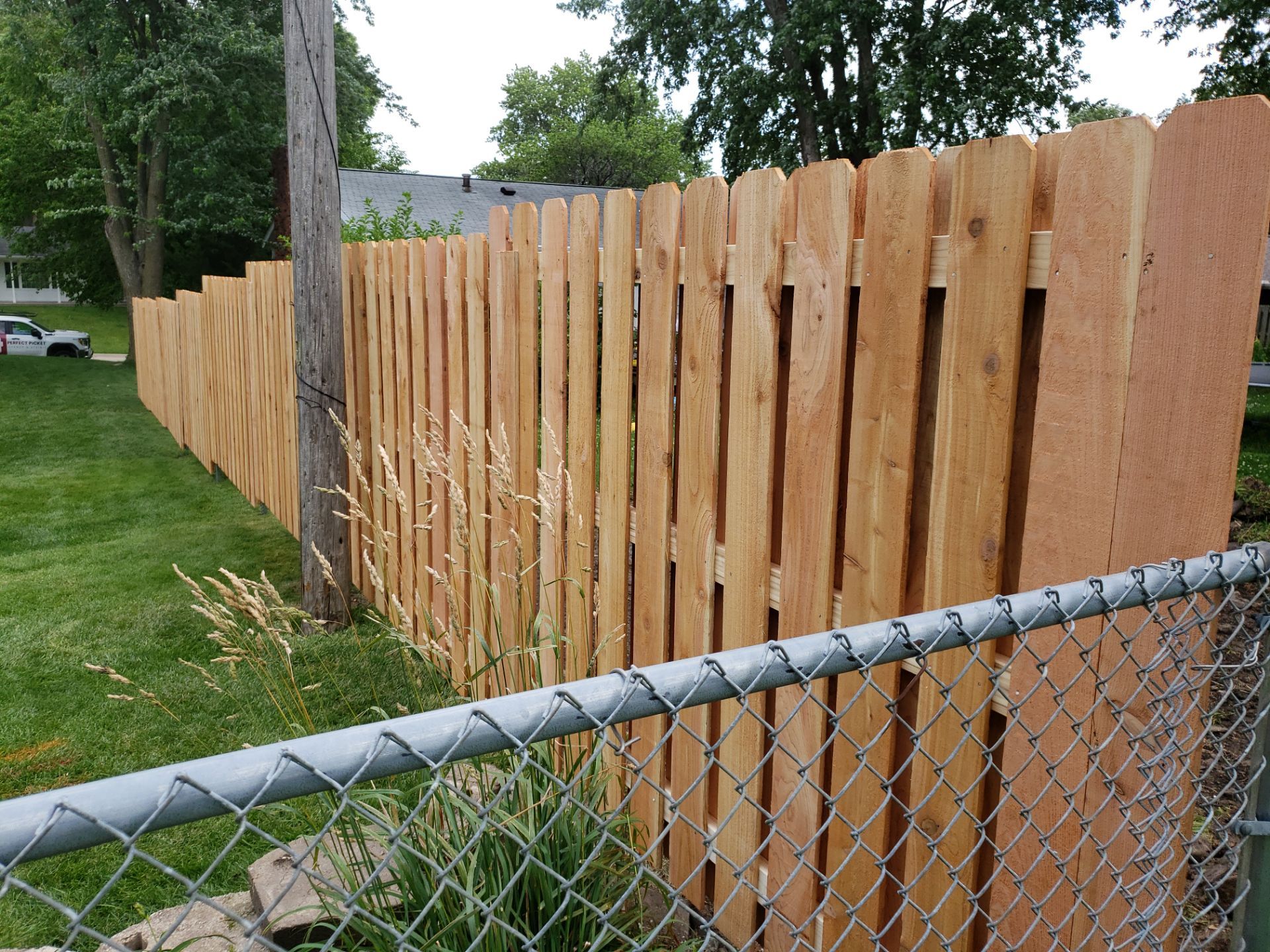Unstained Cedar Wood Privacy Fence Installation in Cedar Falls by Perfect Picket Fence and Stain