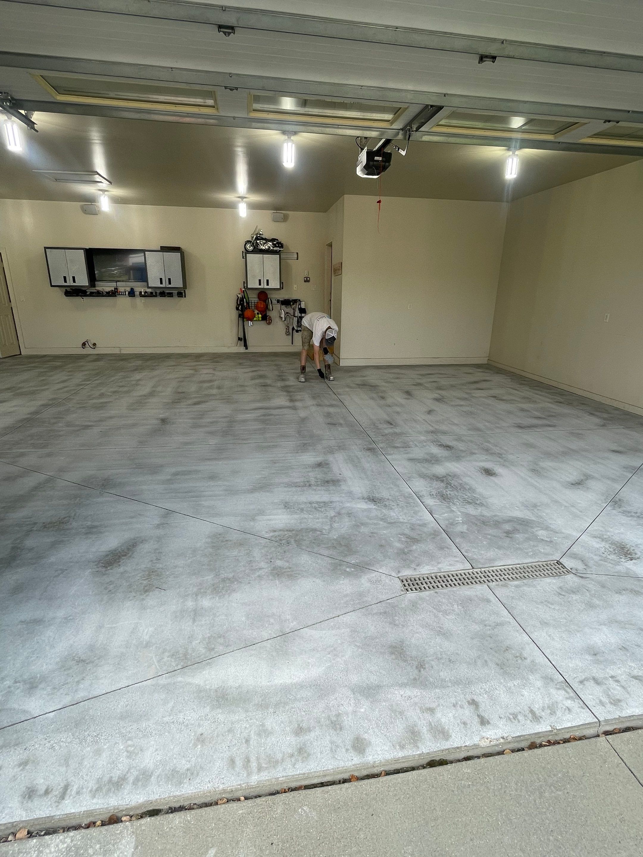 Coyote Flake Garage Floor Coating in Sioux Falls with Trench Drain by Select Painting, Coatings & Garage Cabinets