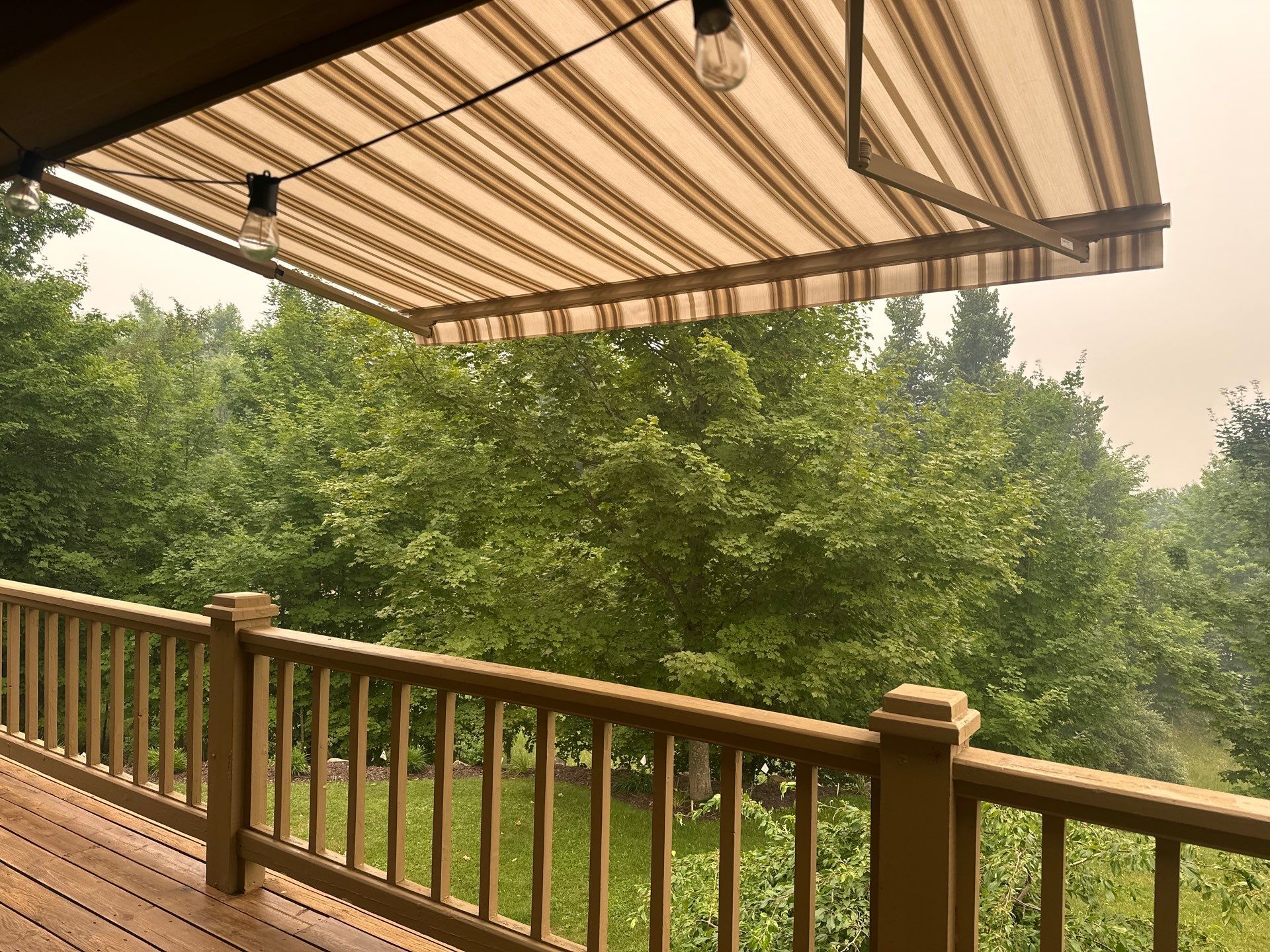 Custom Retractable Awning Installation for Boyne City Deck by Rainbow Seamless Systems