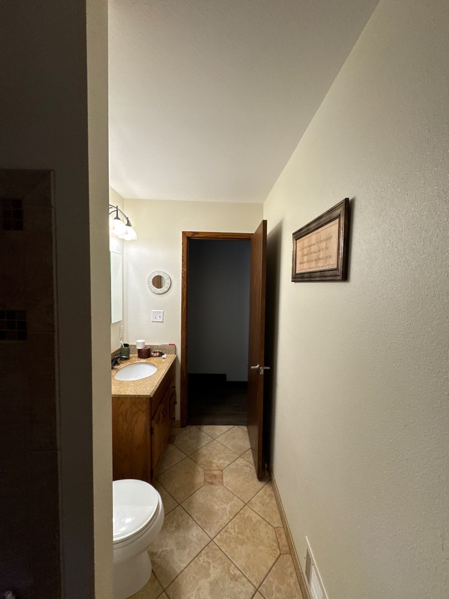 Bathroom Remodel Featuring Stone Tile and Granite Vanity in Mukwonago by OCS Contracting Services