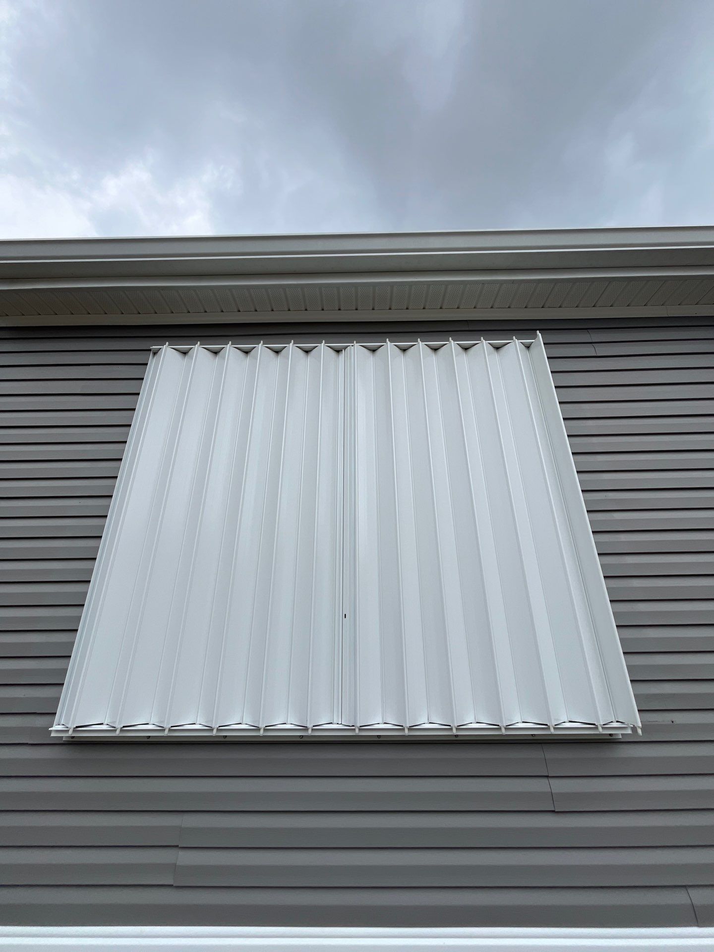 Residential Accordion Hurricane Shutter Installation in Fountain, Florida by Brannan Aluminum Inc.