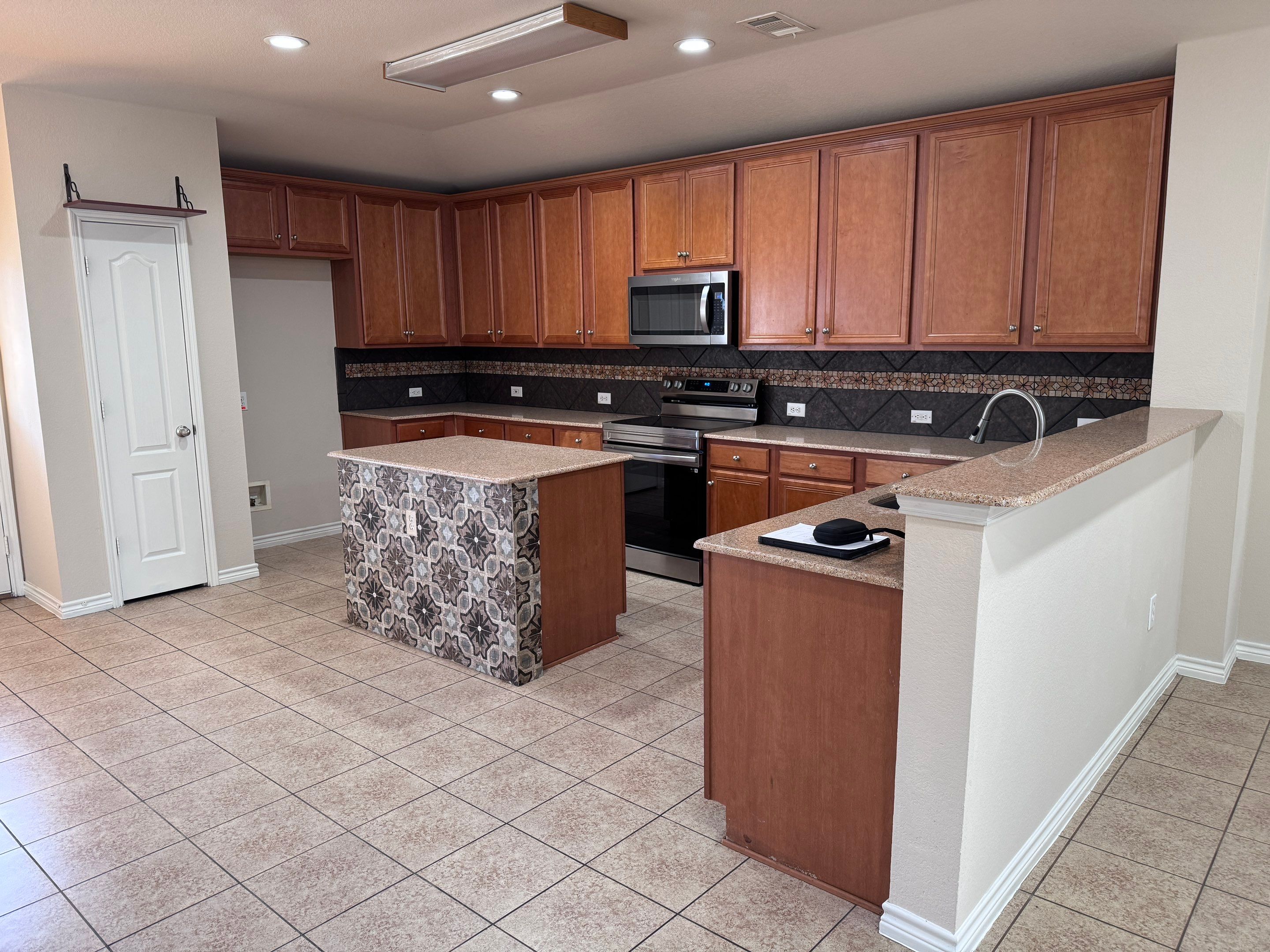 Luxury Focal Point: Full Kitchen Remodel with Double Waterfall Island by Tibi Soli LLC