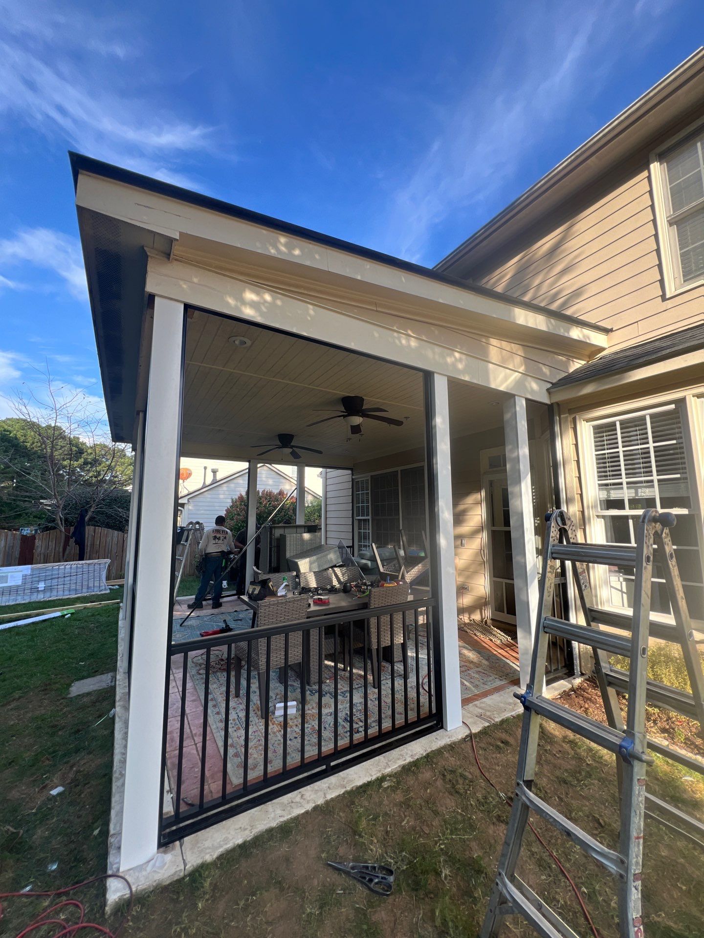 Screened-In Porch Conversion Featuring 6x6 Posts and Black Railings by The Remodeling Company