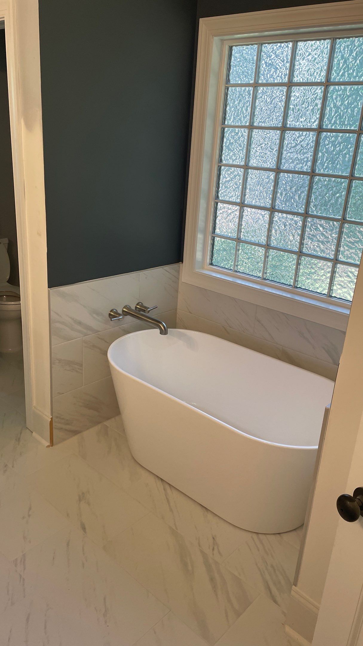 Bright Bathroom Remodel with Wall Removal, Stand Alone Tub and New Vanity by Footprints Floors of Coastal Carolina