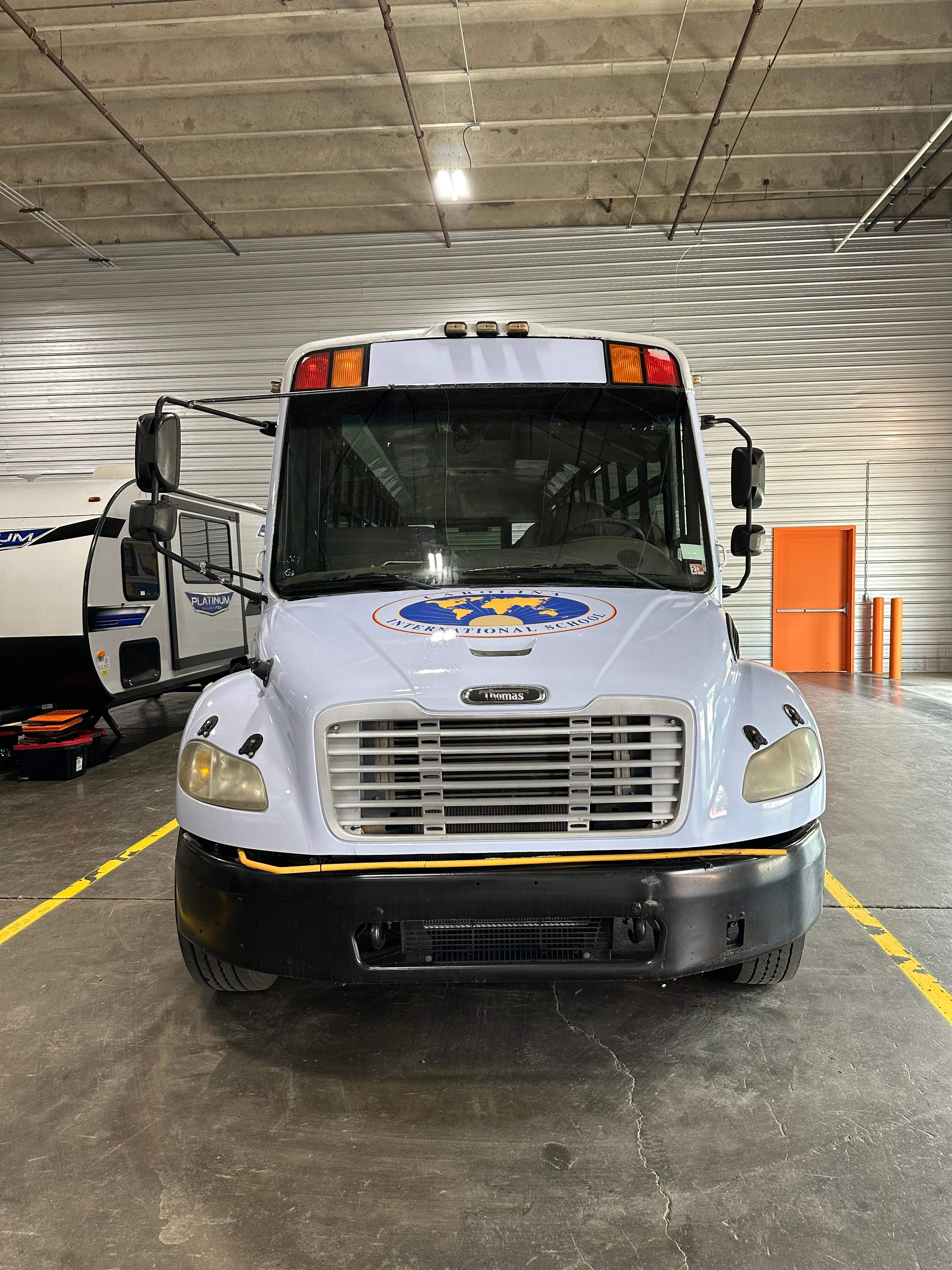 Carolina International School - Bus Vinyl Wrap by QC Signs and Graphics
