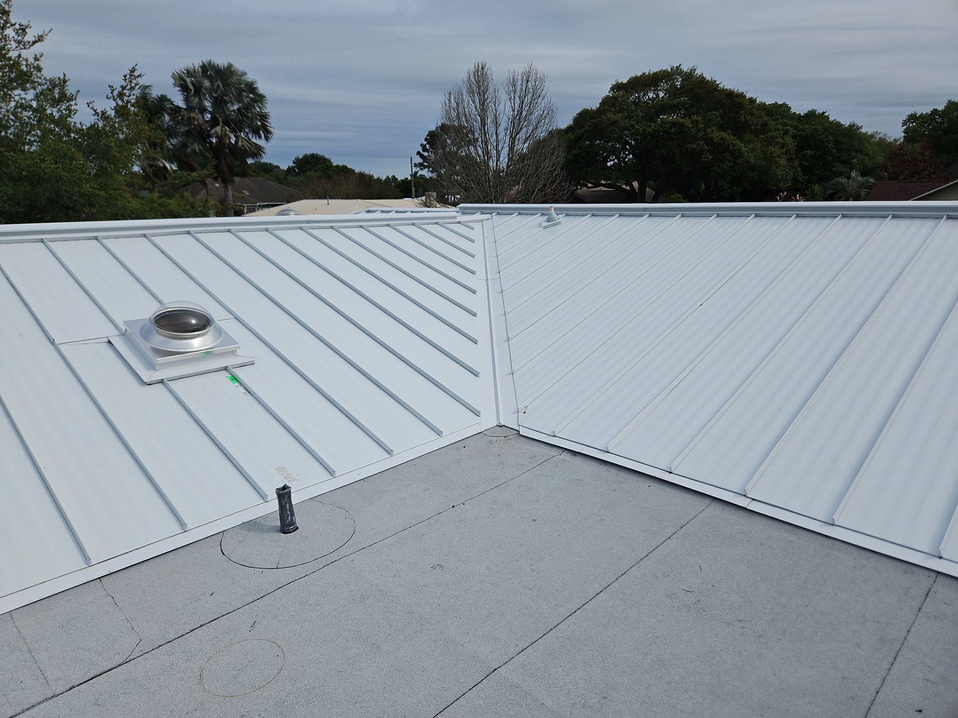 White Standing Seam Metal Roof Replacement and Hurricane Reinforcement in Palm Bay, Florida by Wiedmann Construction & Roofing