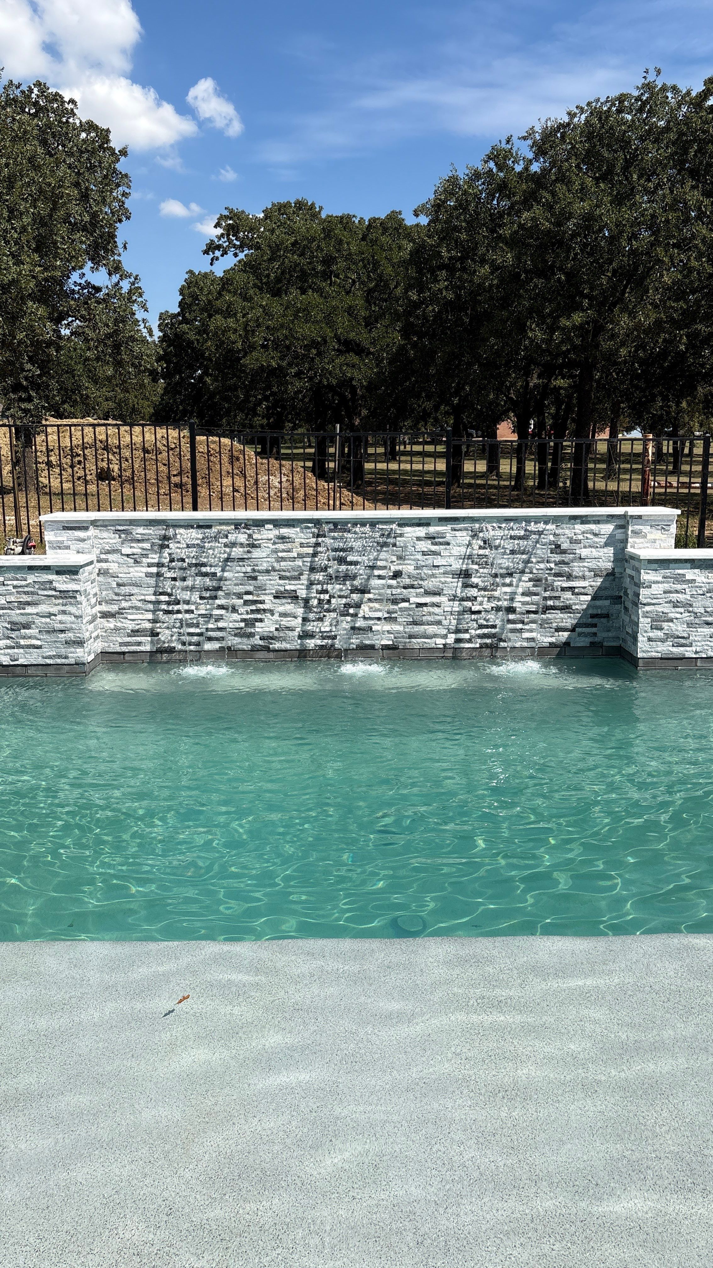 Geometric Pool with Stacked Stone Water Wall by Pinnacle Pools and Spas - DFW