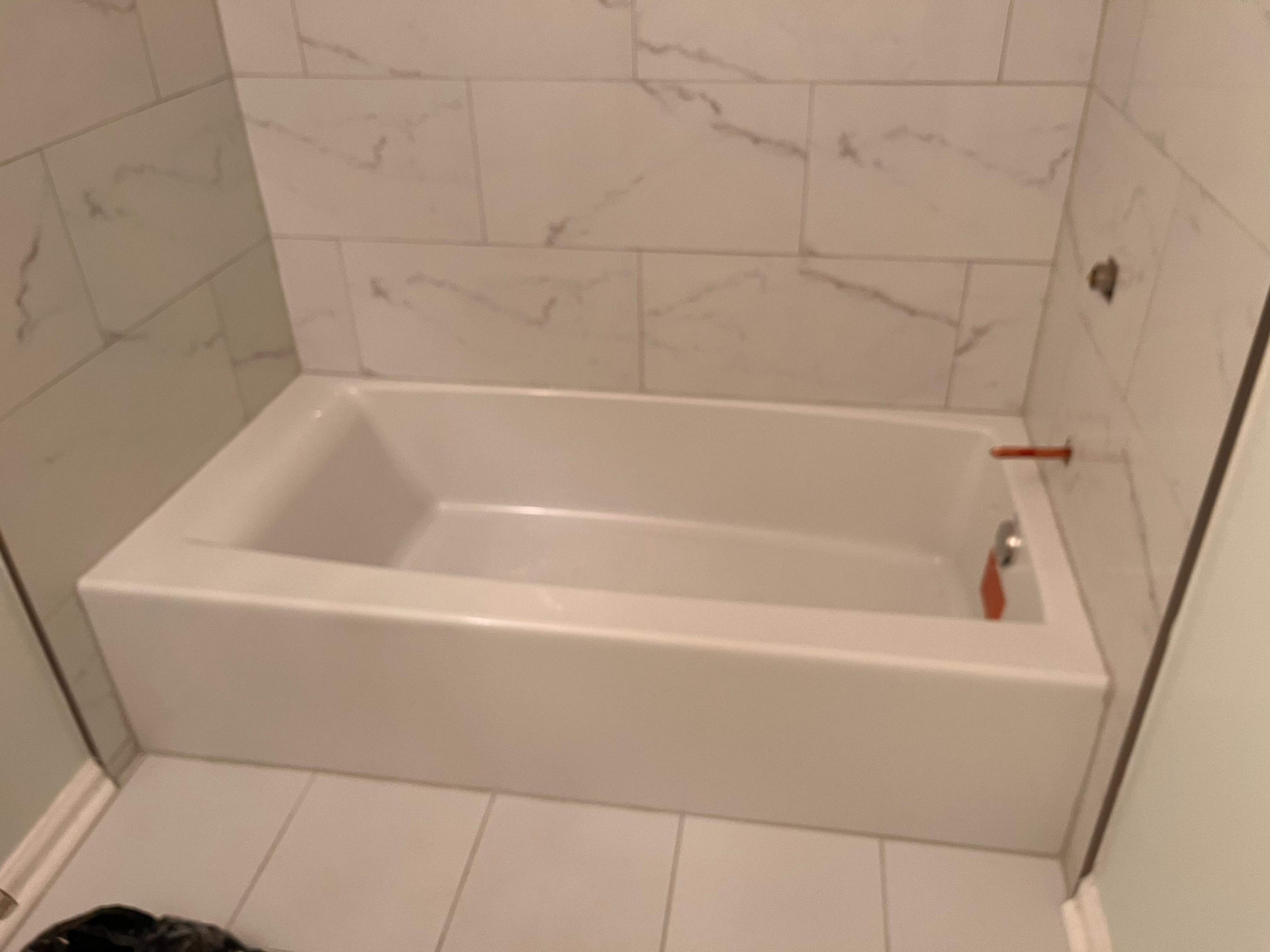 Guest bathroom tub and flooring by Prudencio