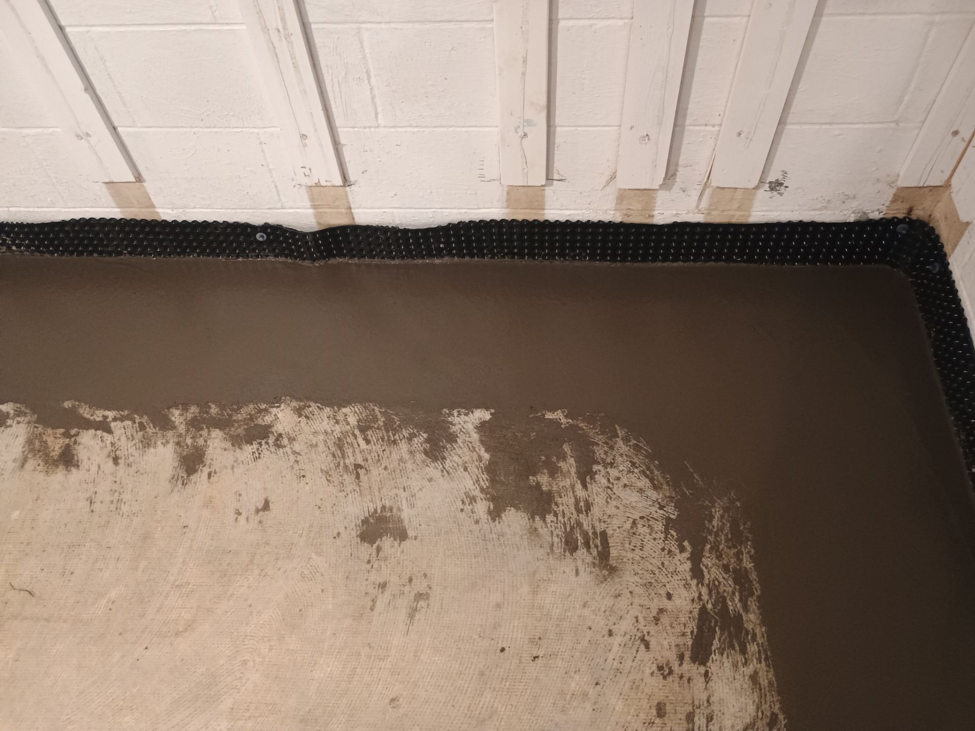 Interior Drain Tile & Buried Discharge in St. Anthony, MN by Waterproofing Northeast