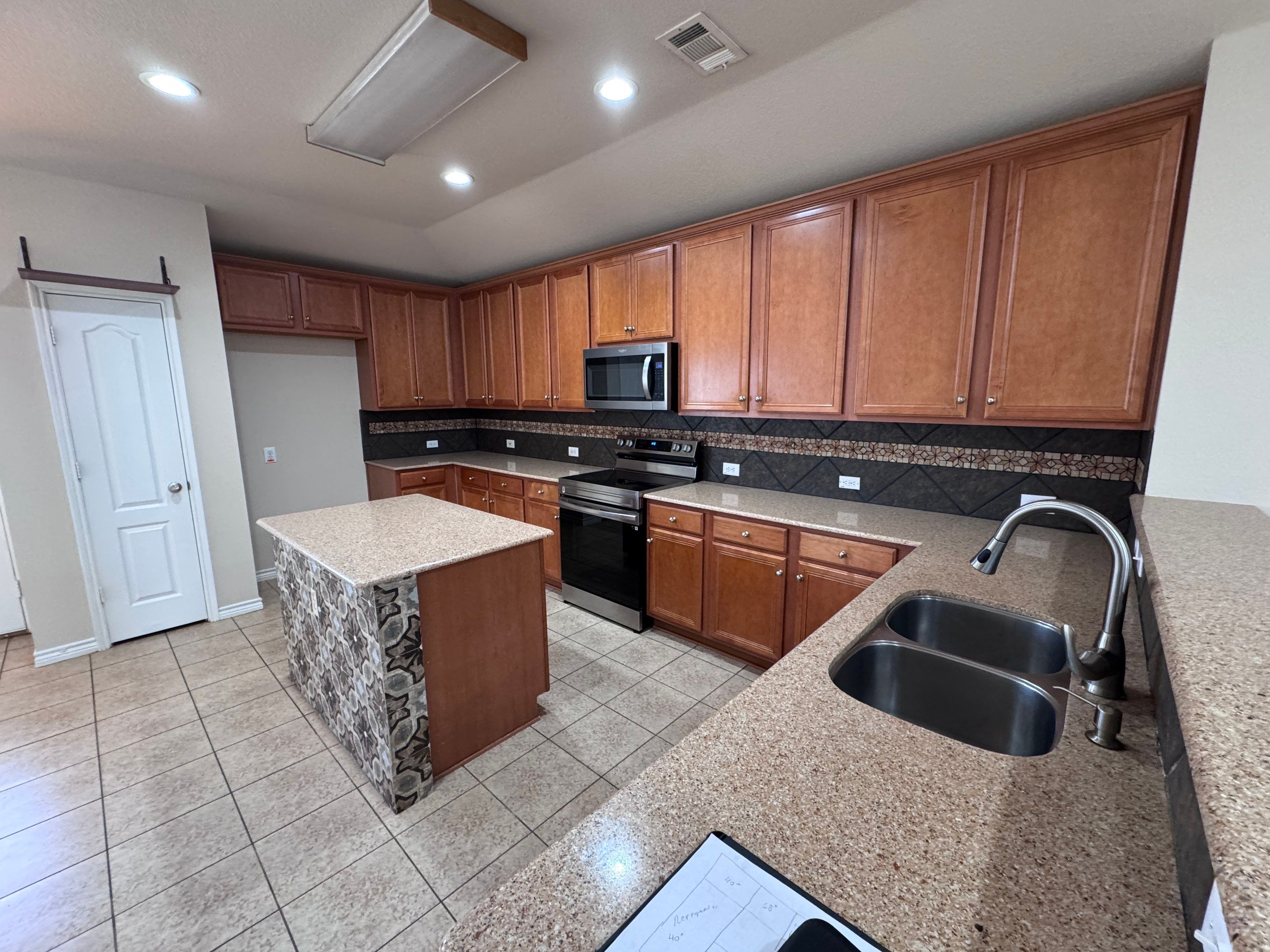 Luxury Focal Point: Full Kitchen Remodel with Double Waterfall Island by Tibi Soli LLC