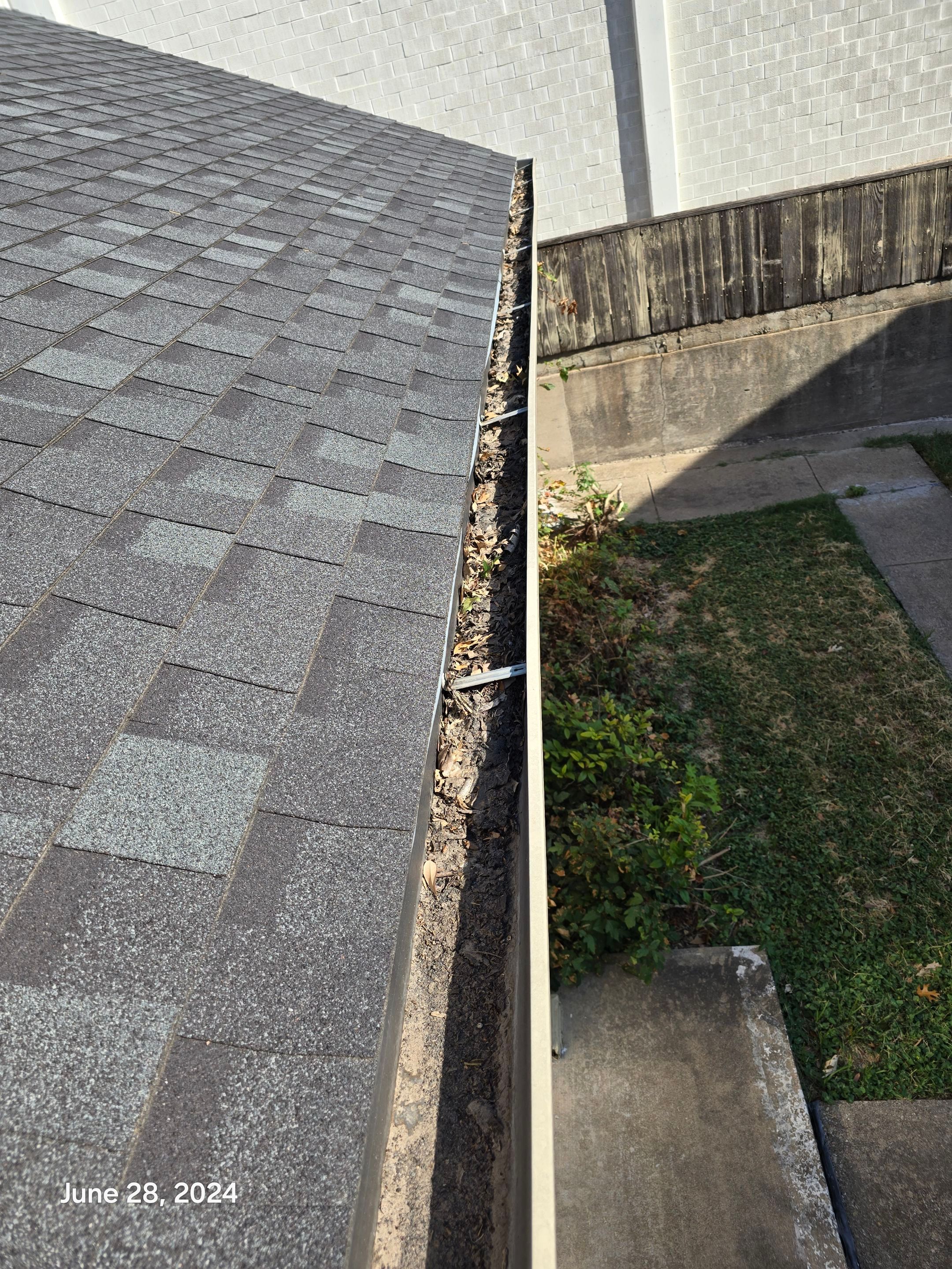 Commercial gutter cleaning Waco, TX before photo with filled gutters