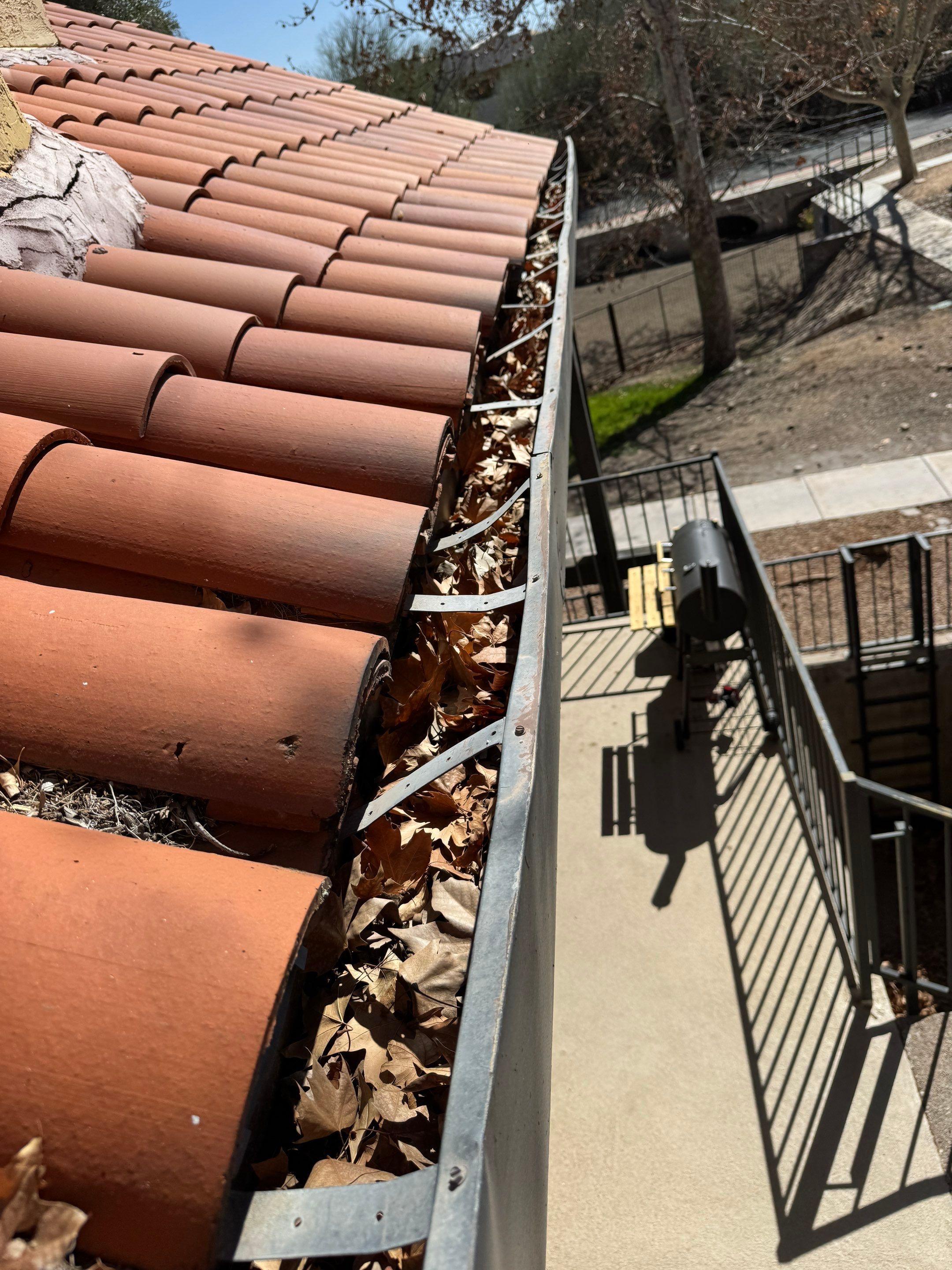 Commercial gutter cleaning Tucson, AZ before photo with filled gutters