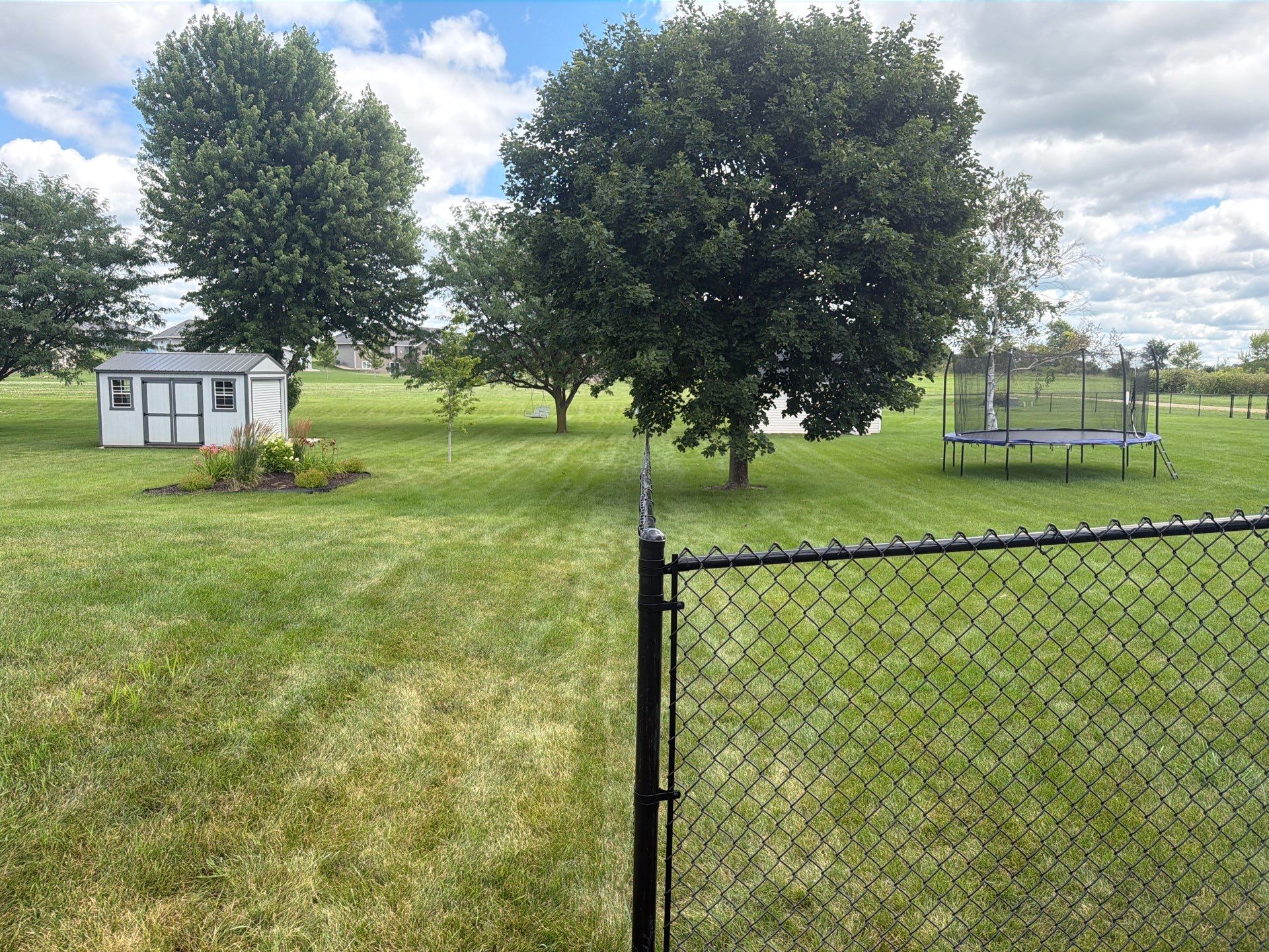 Black Vinyl-Coated Chain Link Fence Installation in Fairbank by Perfect Picket Fence and Stain