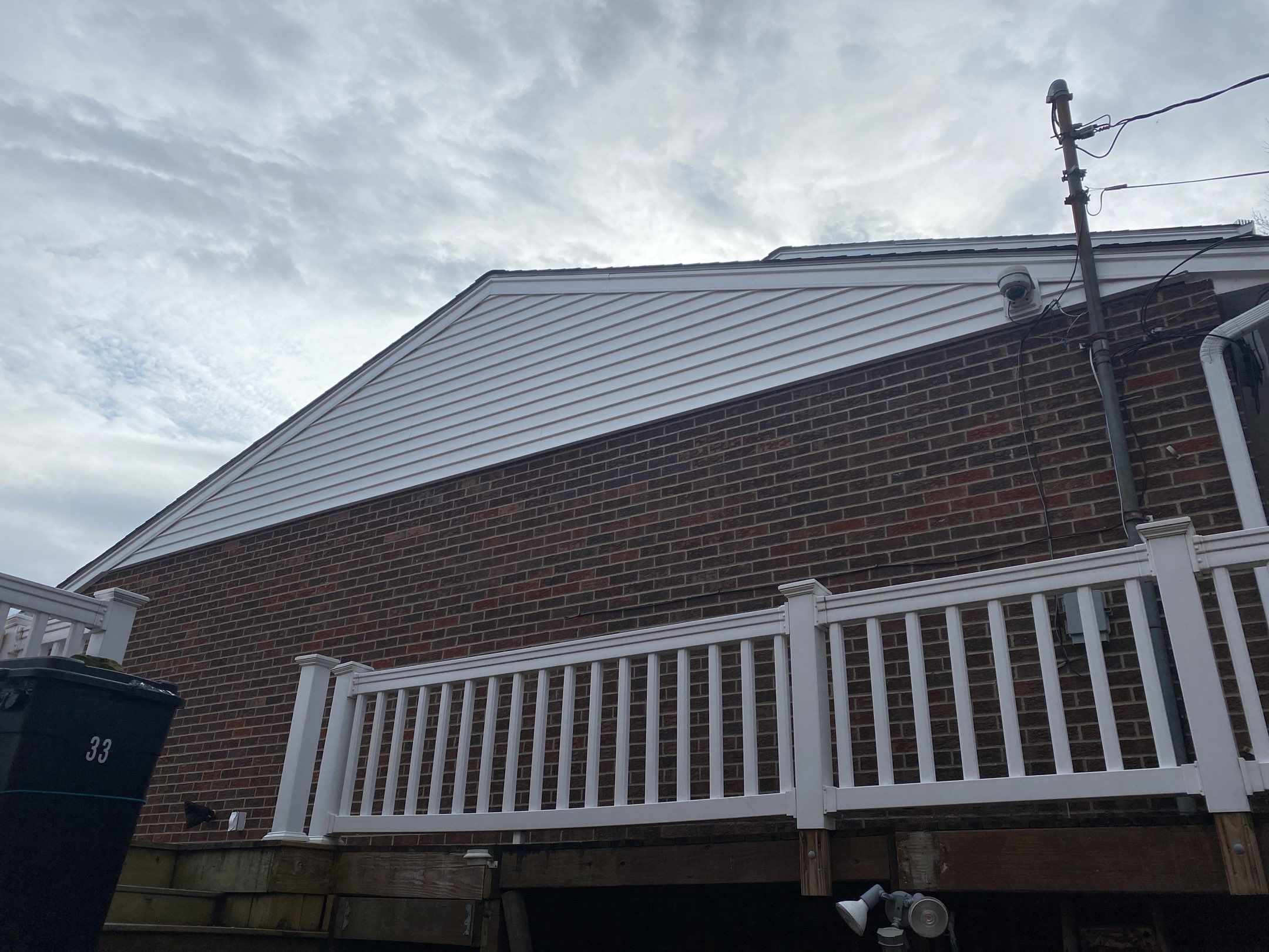 Replace dated vinyl siding with new white exterior Portfolio vinyl siding  by Secure Construction Company Inc