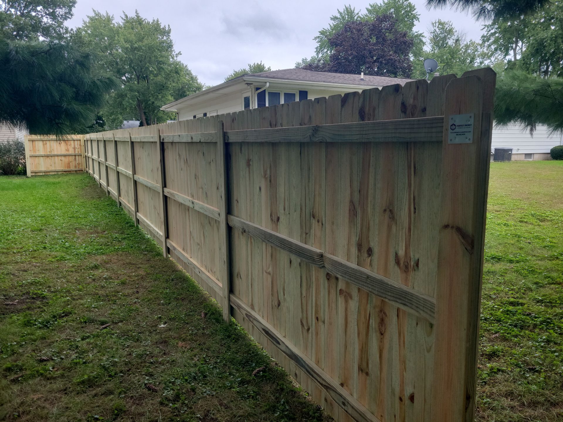 Pressure-Treated Wood Privacy Fence Installation in Waverly by Perfect Picket Fence and Stain