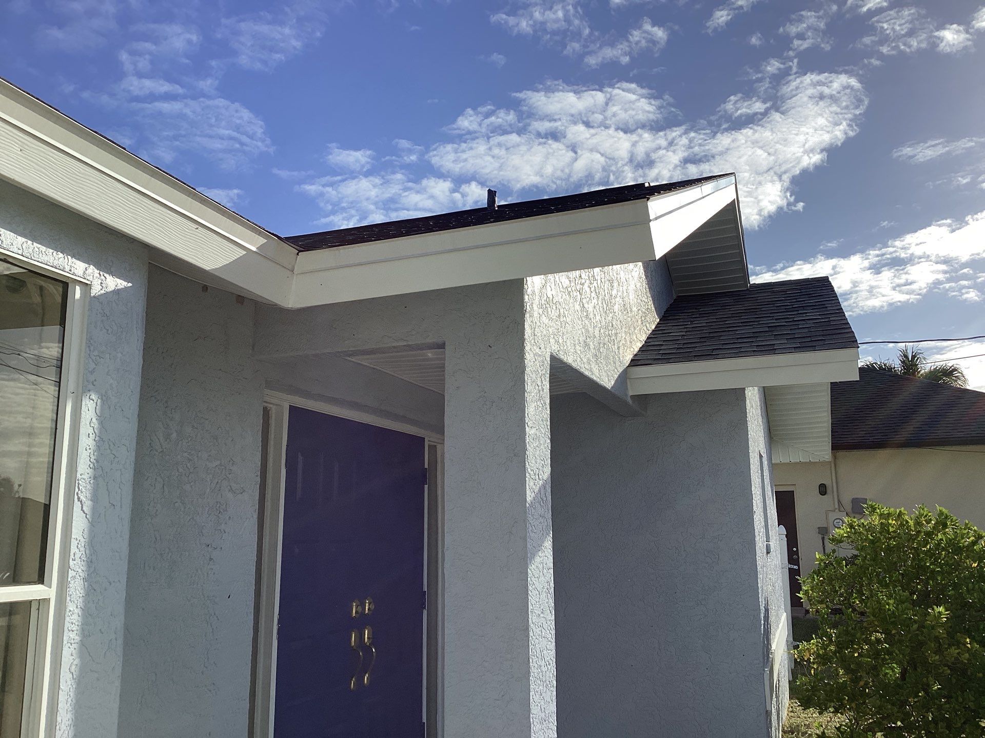 New White Seamless Gutters with Downspouts and Splash Guards in Cape Coral FL by Gutter Professors