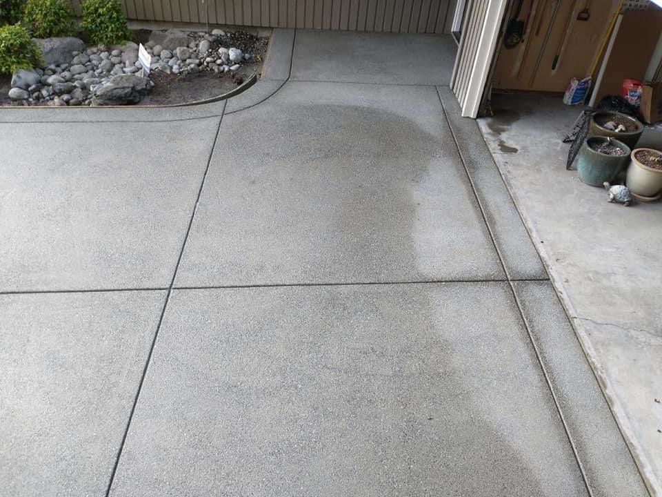 Cristi | Sand Finish Concrete Driveway  by Jireh Asphalt & Concrete Inc 