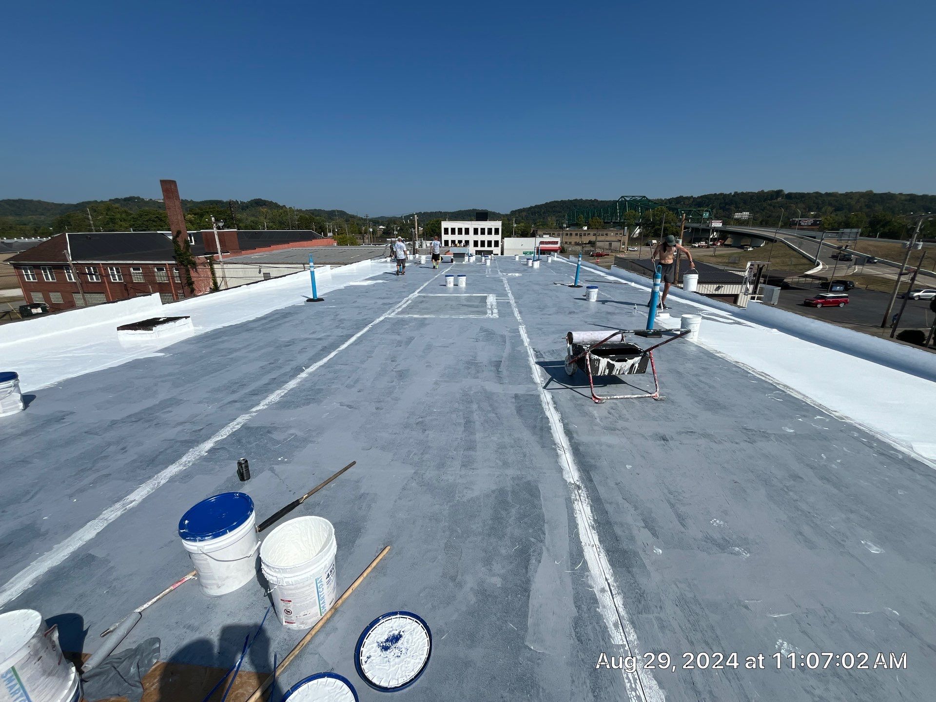 Commercial Roofing Installation using smartcoat Roof coating by Fahey Roofing + Contracting