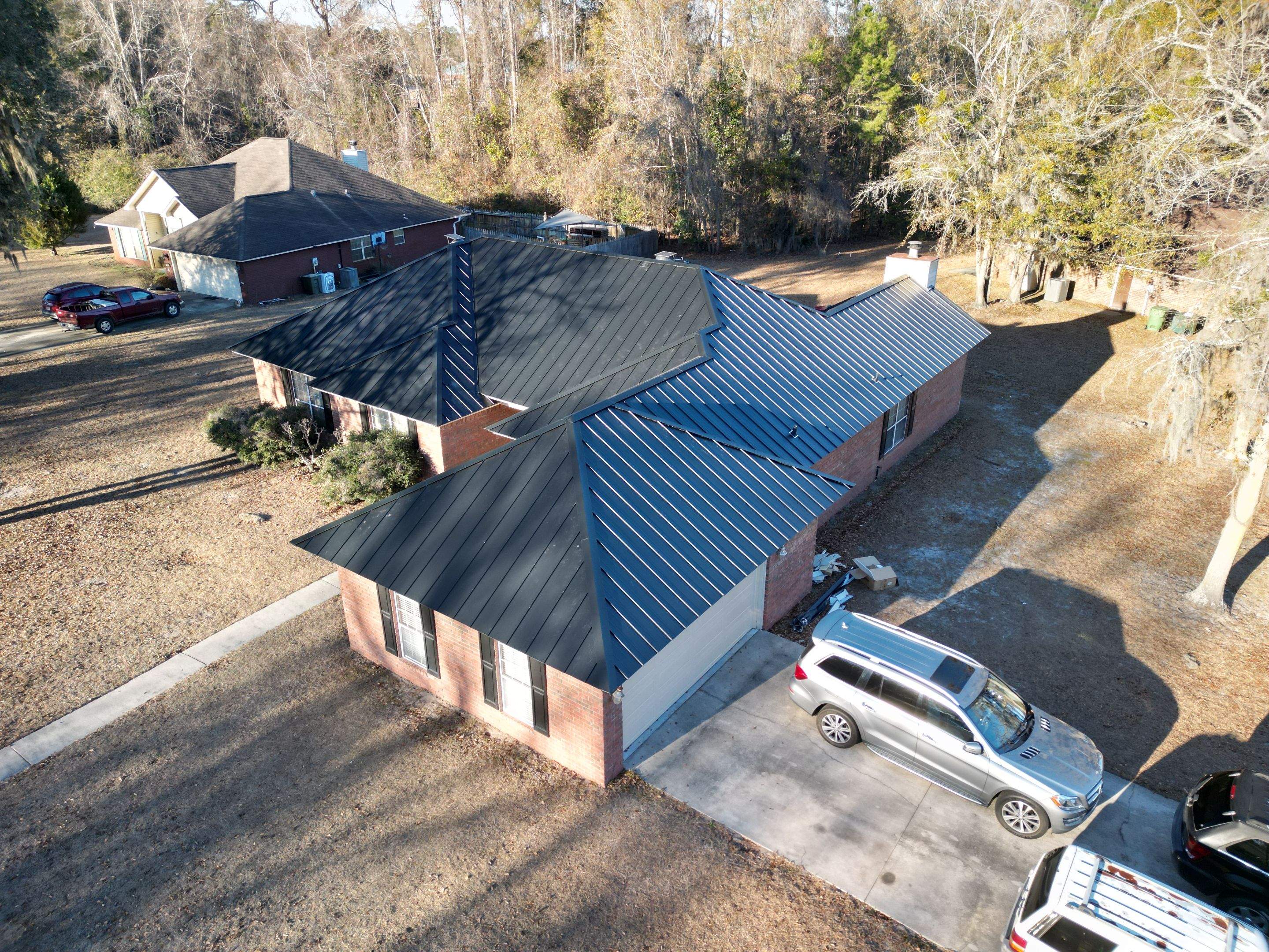 Residential Roofing Installation using Benton 26Ga 1inc Snapcock Metal Roof KYNAR Matte Black by Talya Roofing