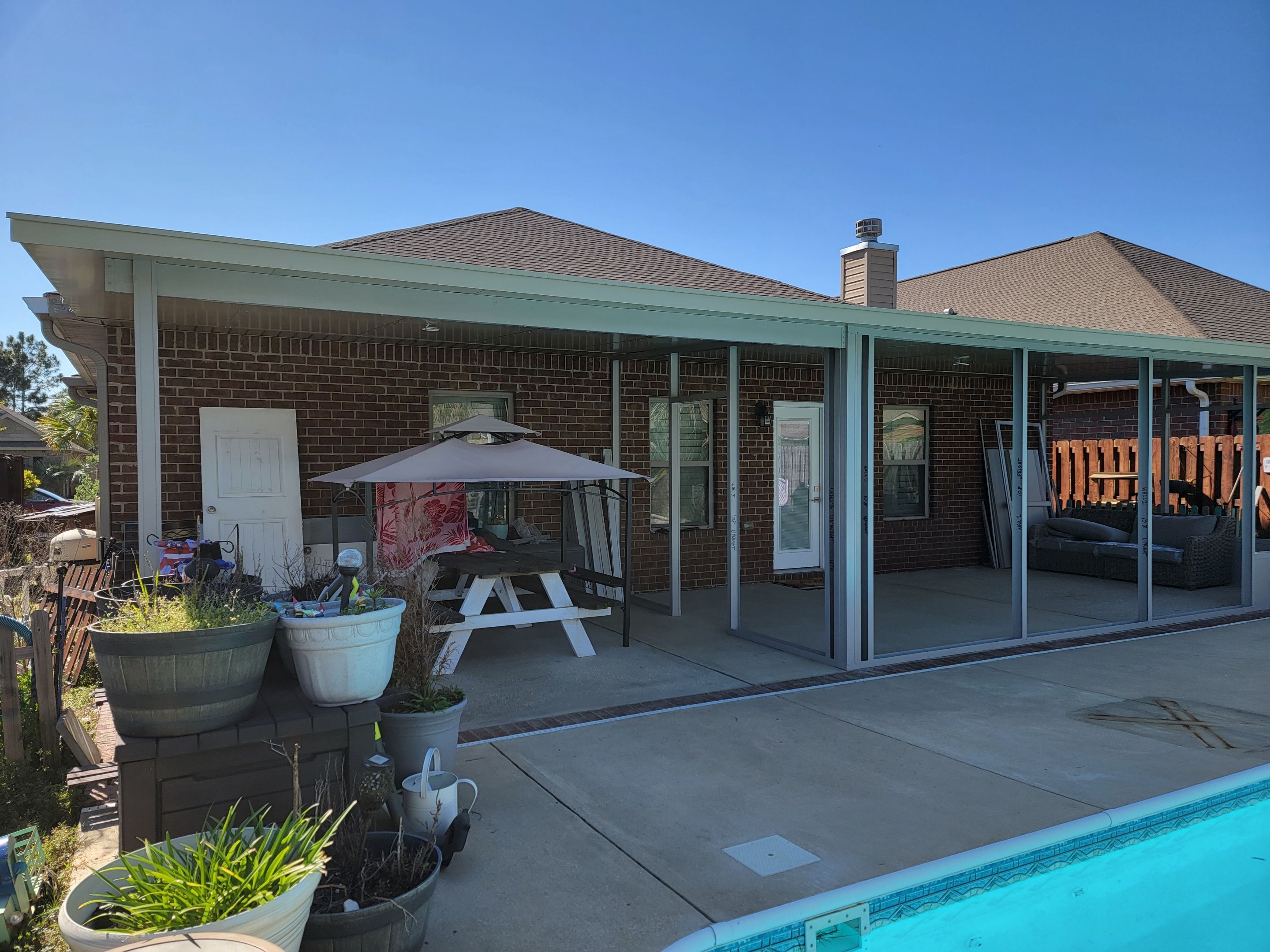 Poolside Screen Room & Patio Cover in Gulf Breeze by Titan Sunrooms