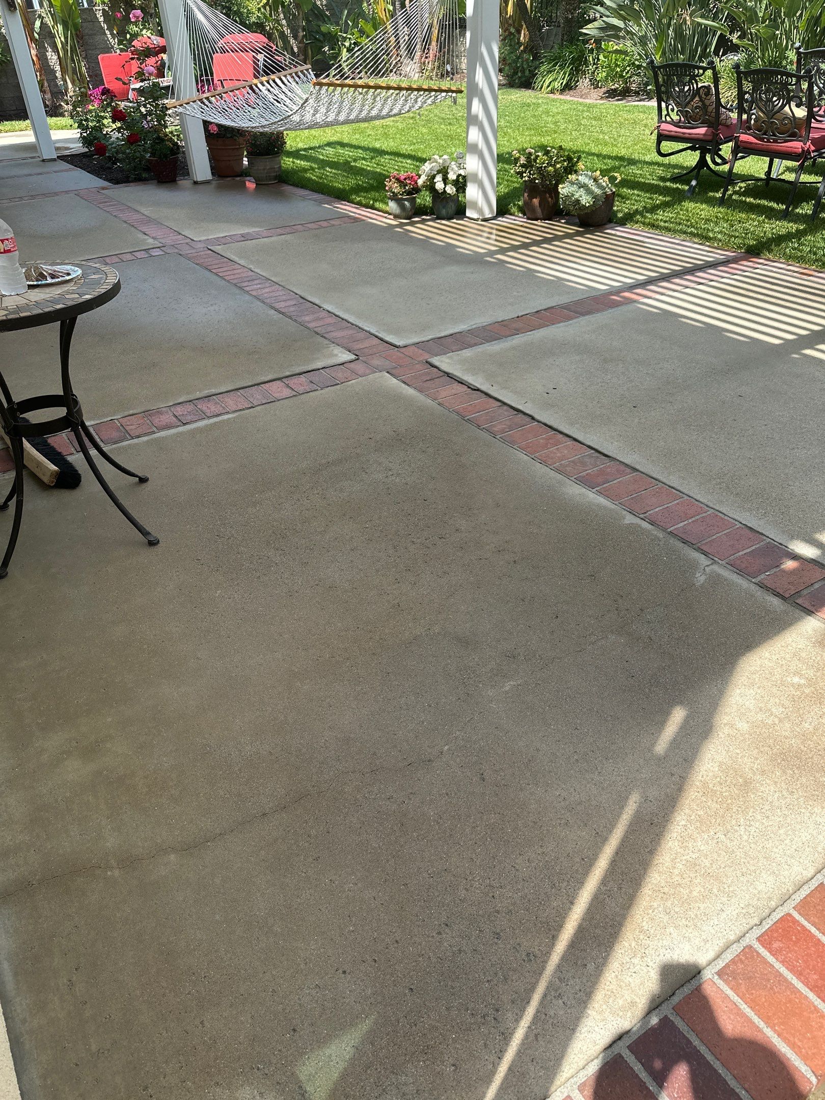 Surface cleaning pressure washing in Orange County on patio, walkways, and driveway by Property Cleaning Experts, LLC