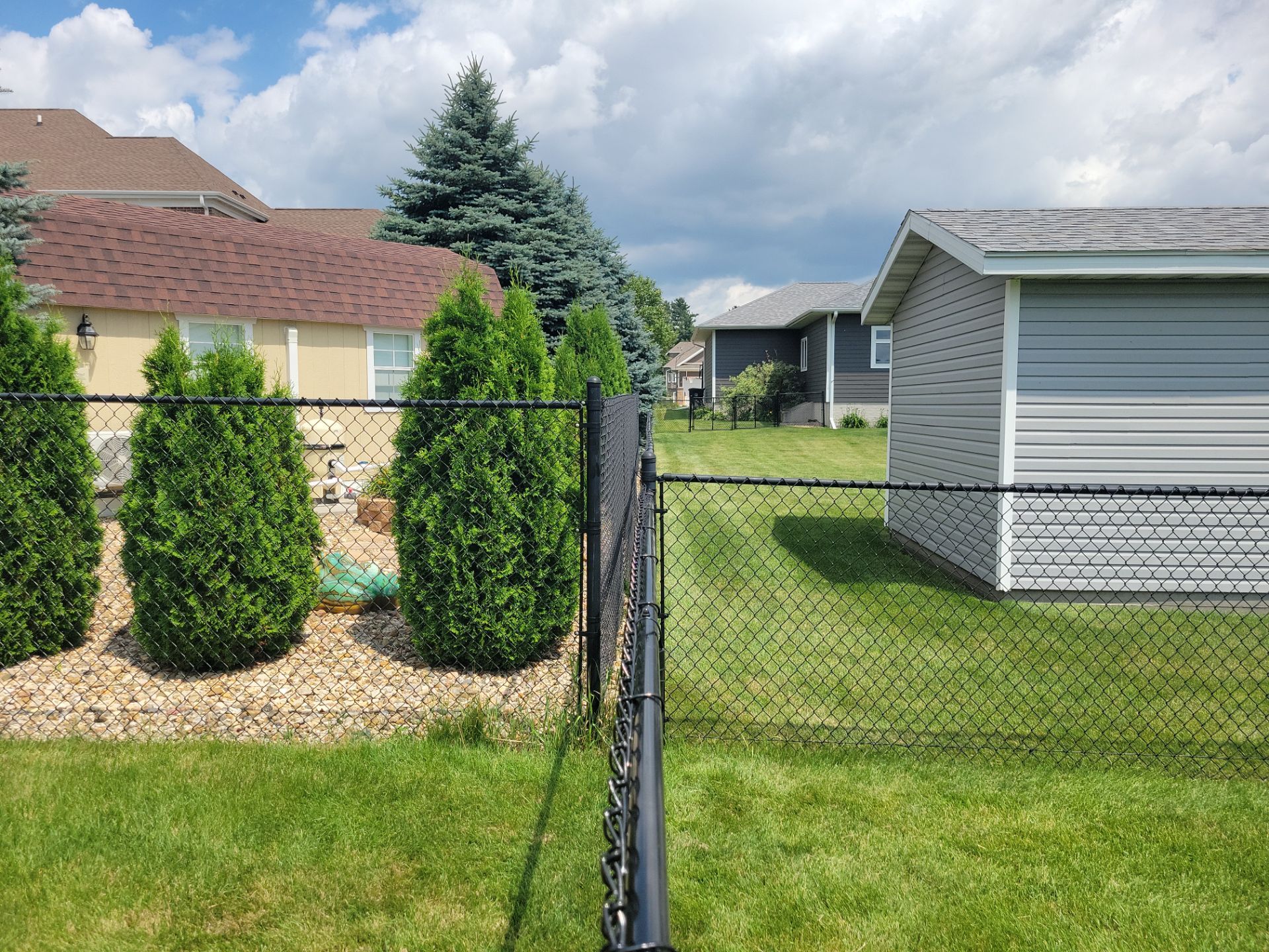 Black Vinyl Coated Chain Link Fence Installation in Cedar Falls by Perfect Picket Fence and Stain